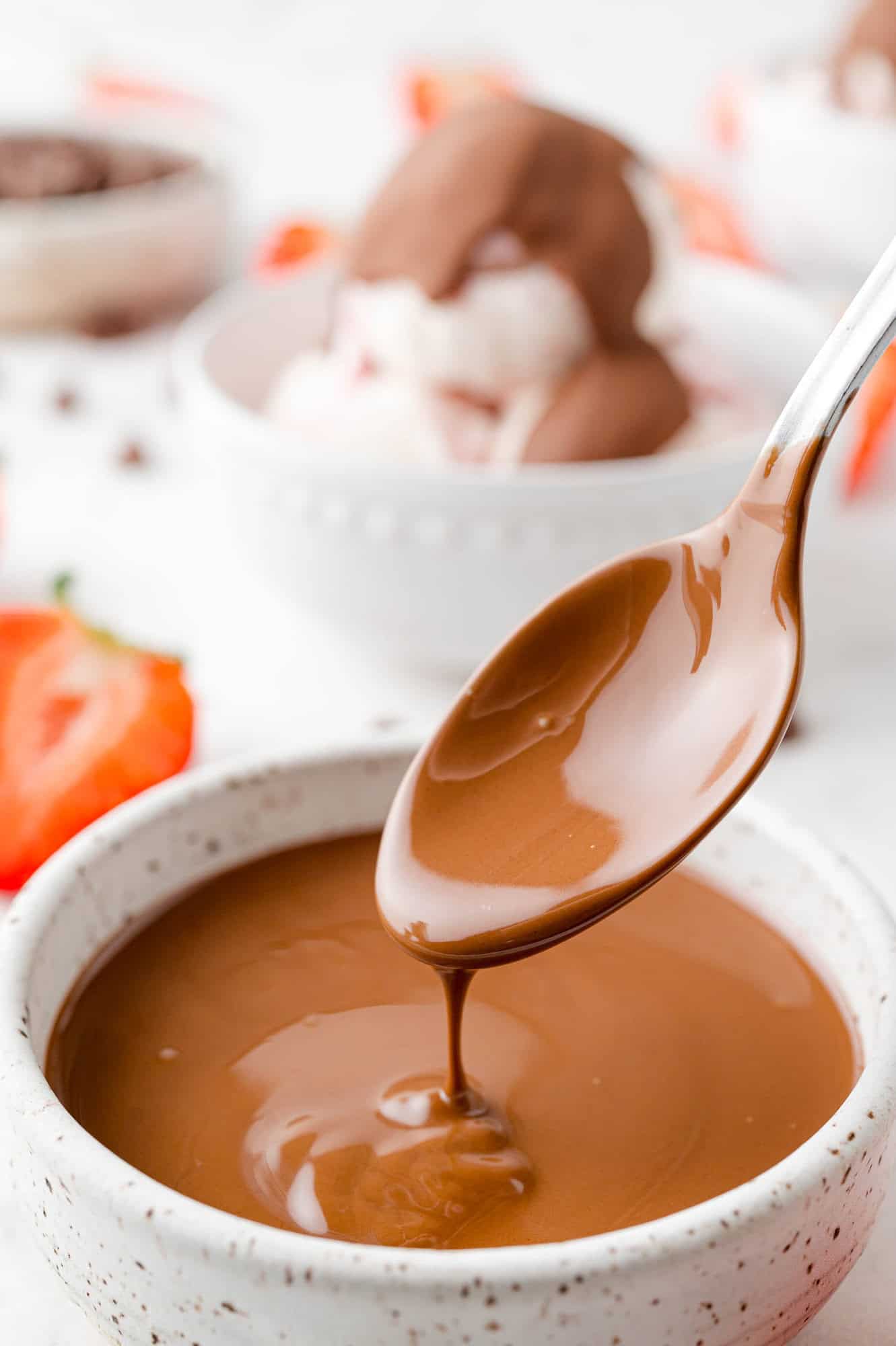 Chocolate magic shell on a spoon, in its liquid format.