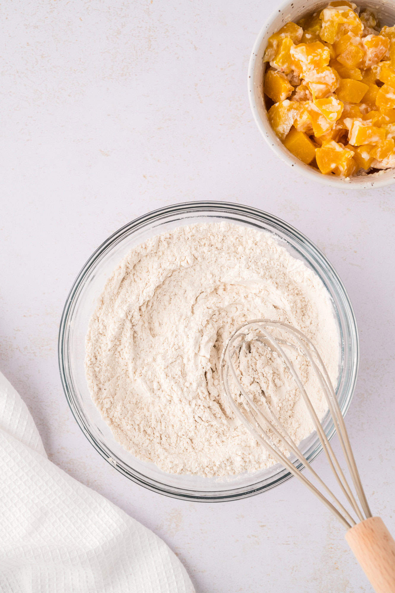 Dry ingredients being mixed with a whisk.