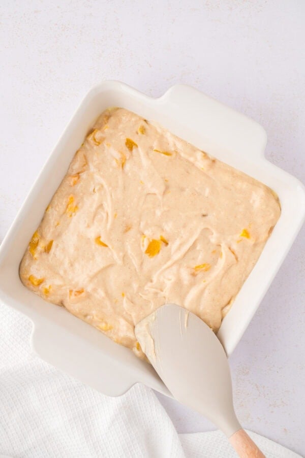 Batter being spread into baking dish.