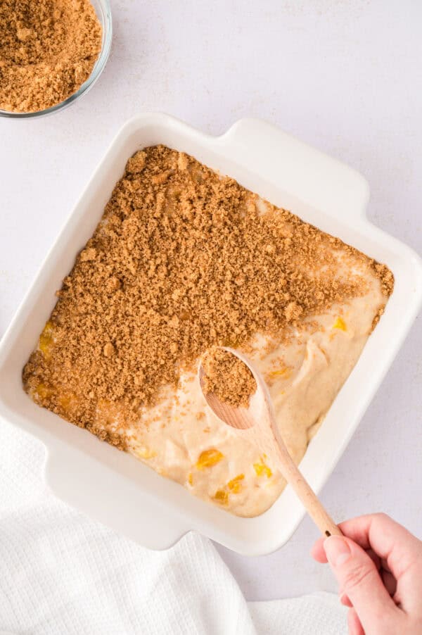 Streusel being added to the top of the batter.