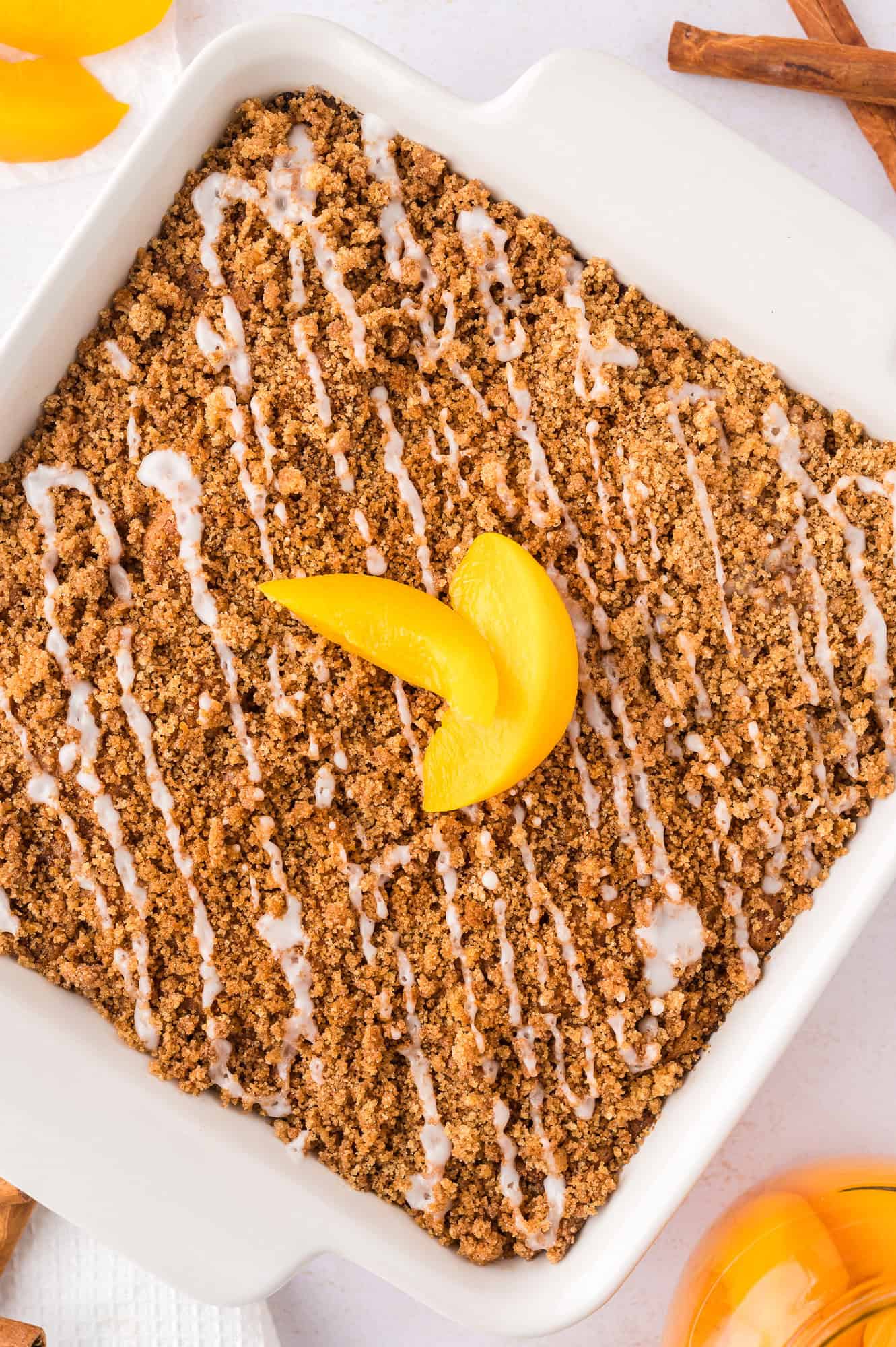 Overhead view of coffee cake topped with sliced peaches.