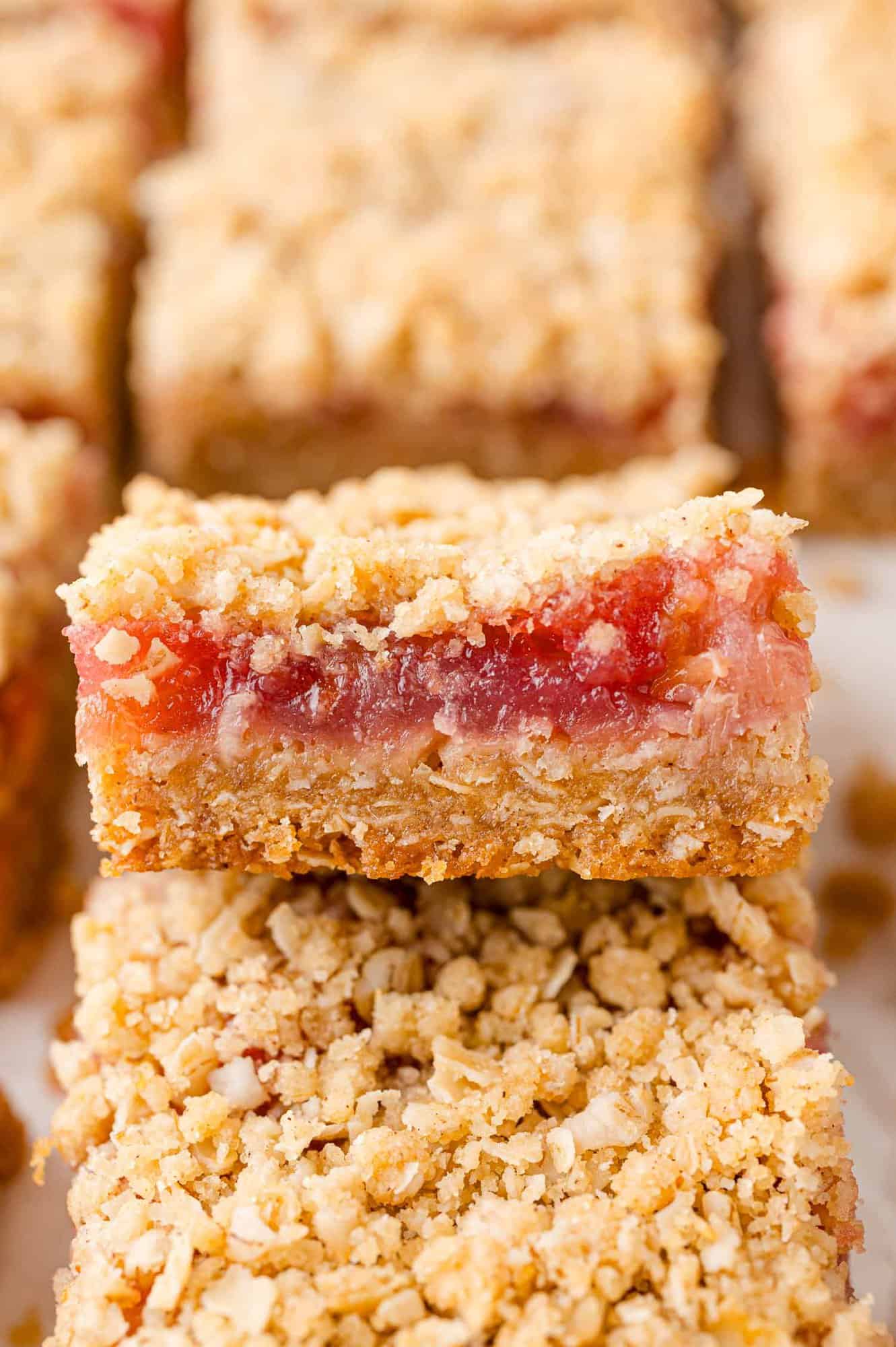 Rhubarb bars, with crumb topping, stacked on each other.