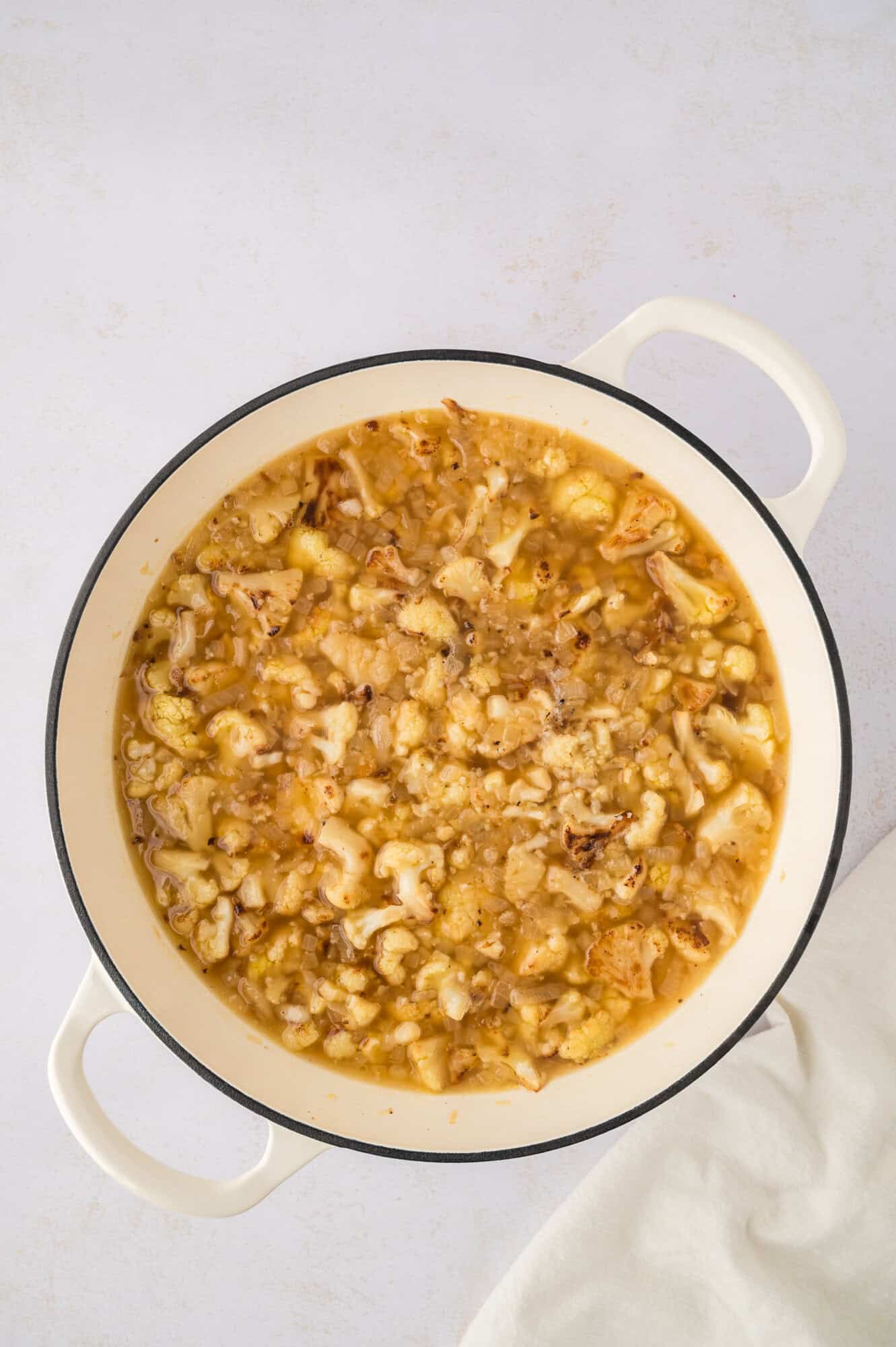 Cauliflower and broth after being cooked in dutch oven.