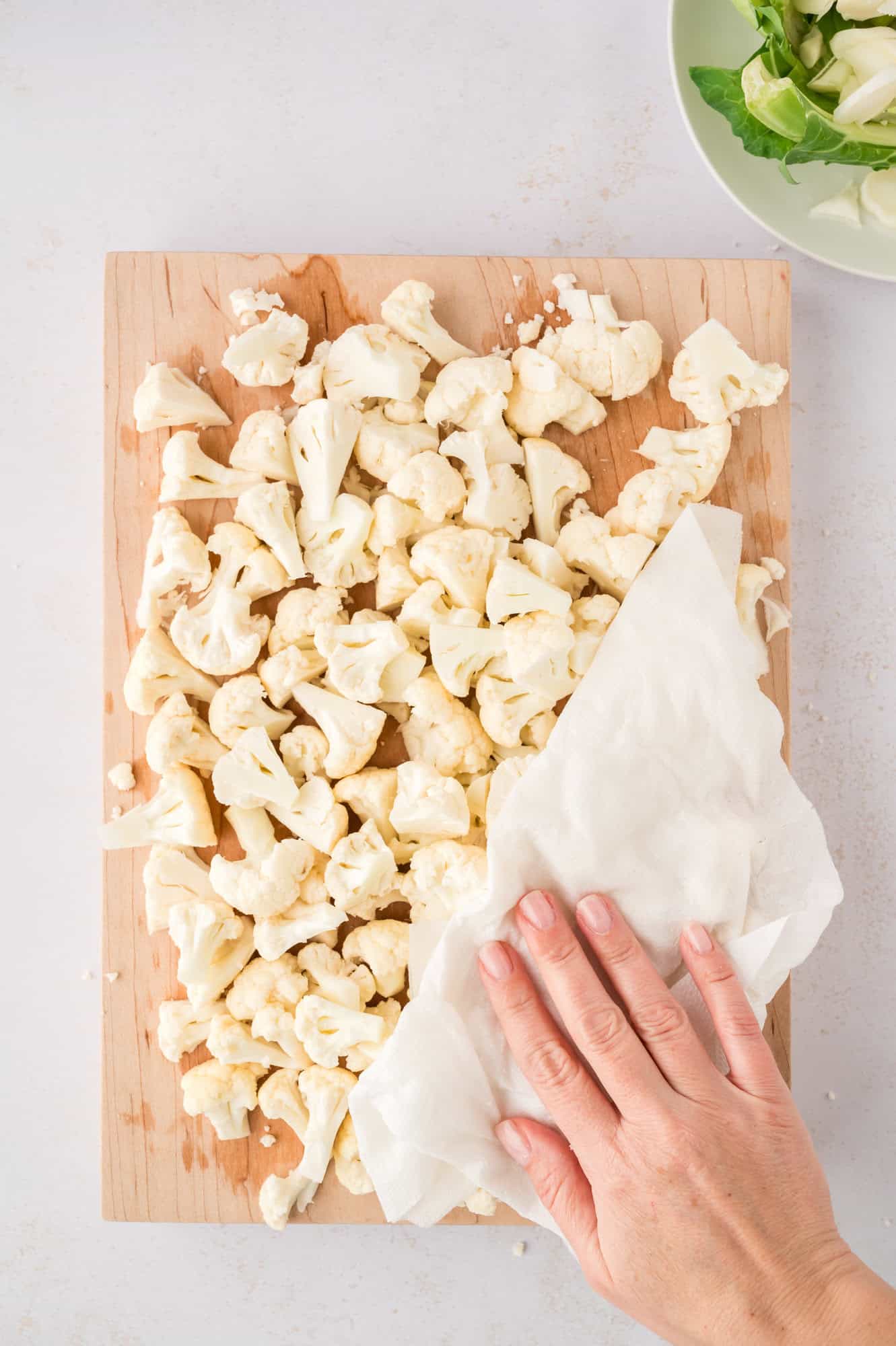 Cauliflower being patted dry.