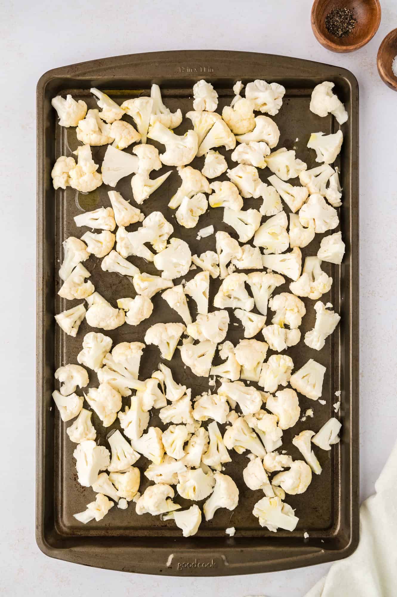 Chopped cauliflower on a baking sheet.