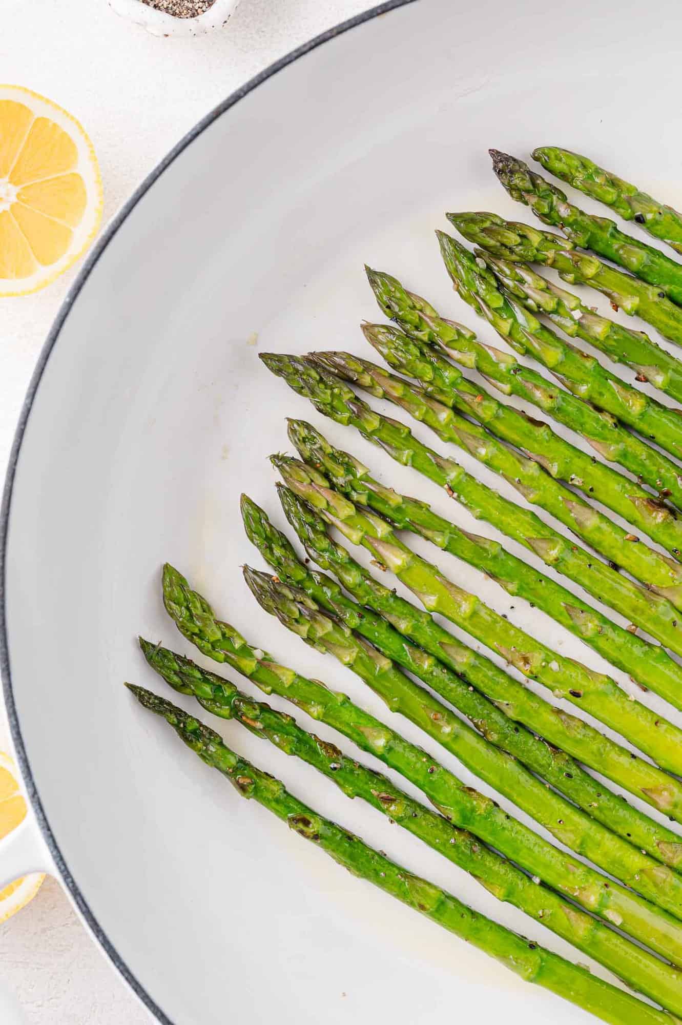 Cooked asparagus in frying pan.