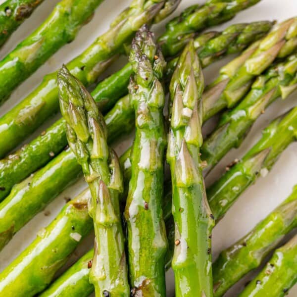 Sautéed asparagus spears, layered on top of each other.