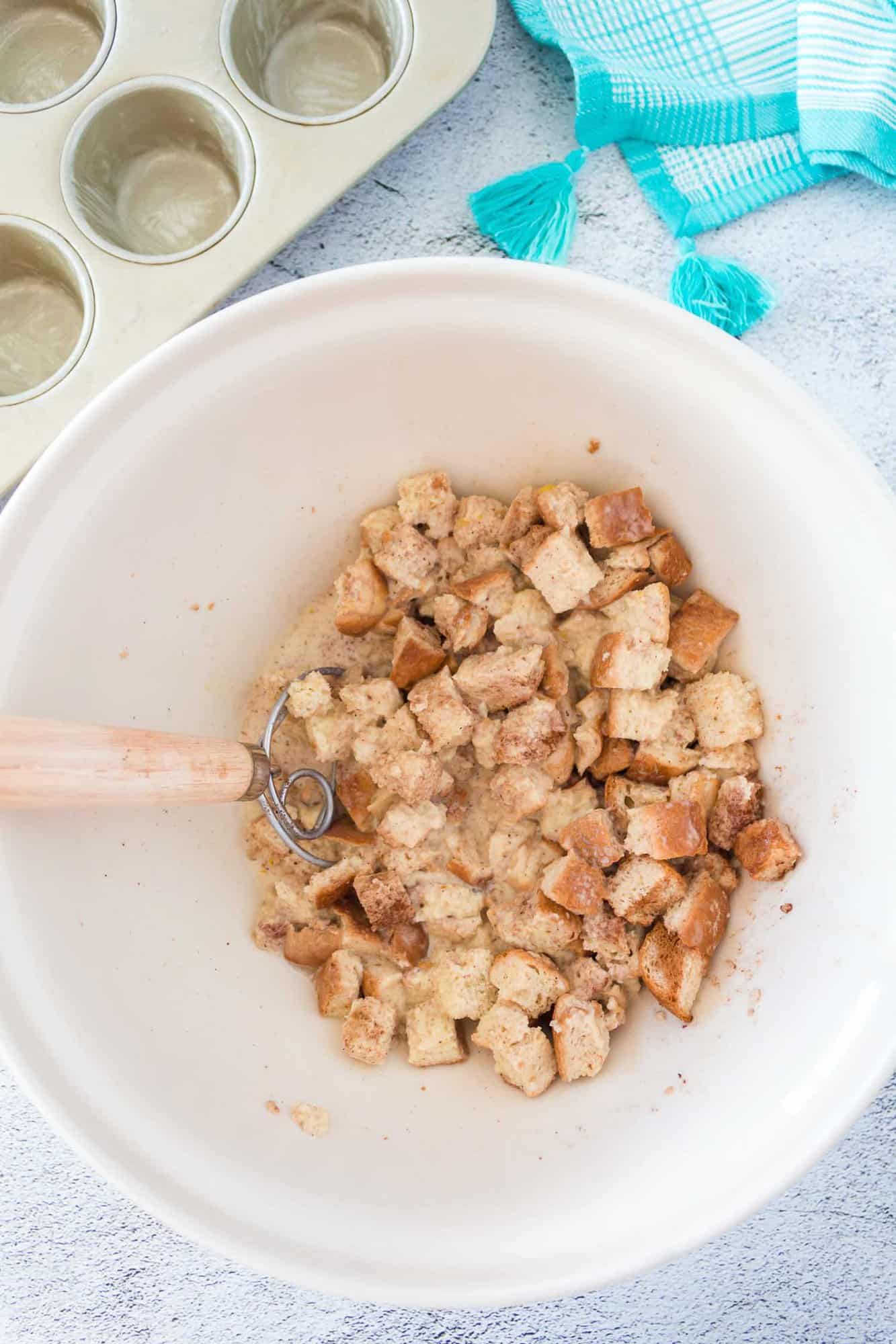 Bread cubes added to custard mixture.
