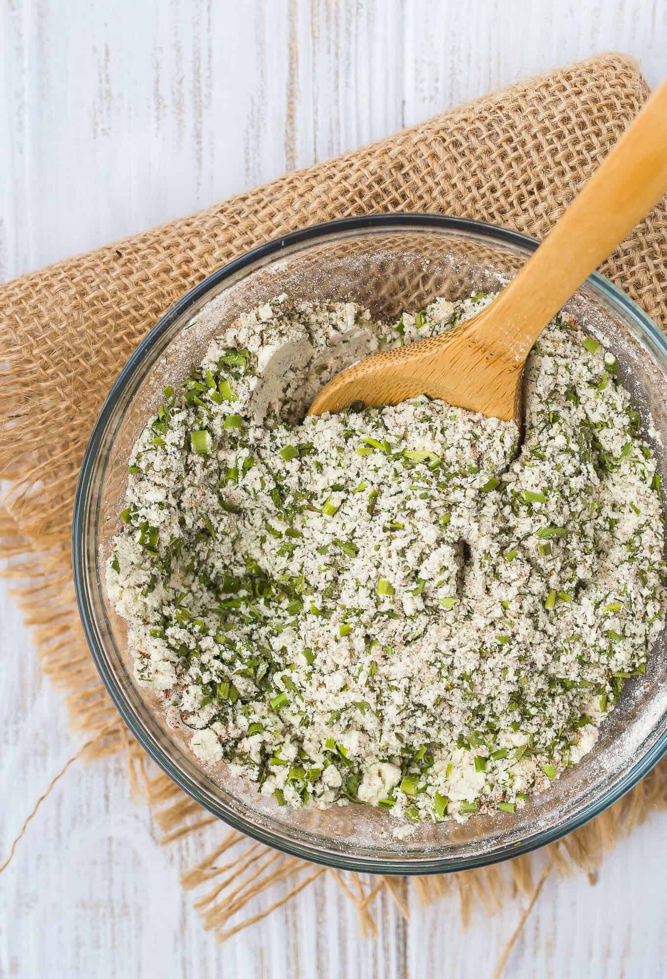 Ranch seasoning mix with a small wooden spoon.