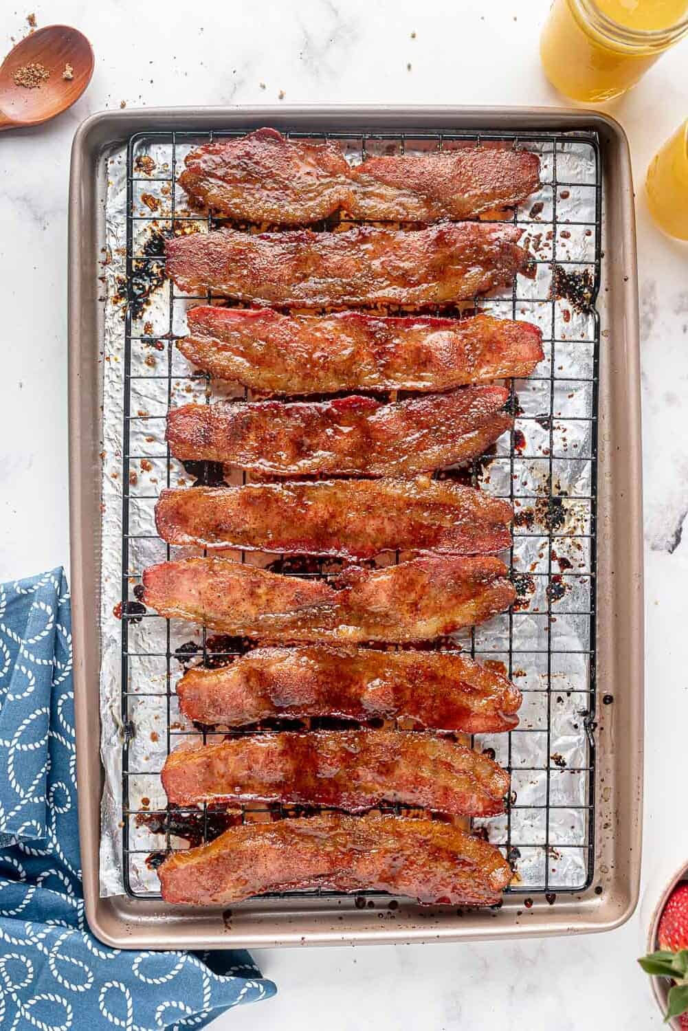 Cooked candied bacon on a wire rack.