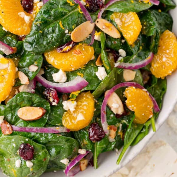 Mandarin orange salad on a bed of spinach.