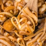 Sautéed onions on a wooden spoon.