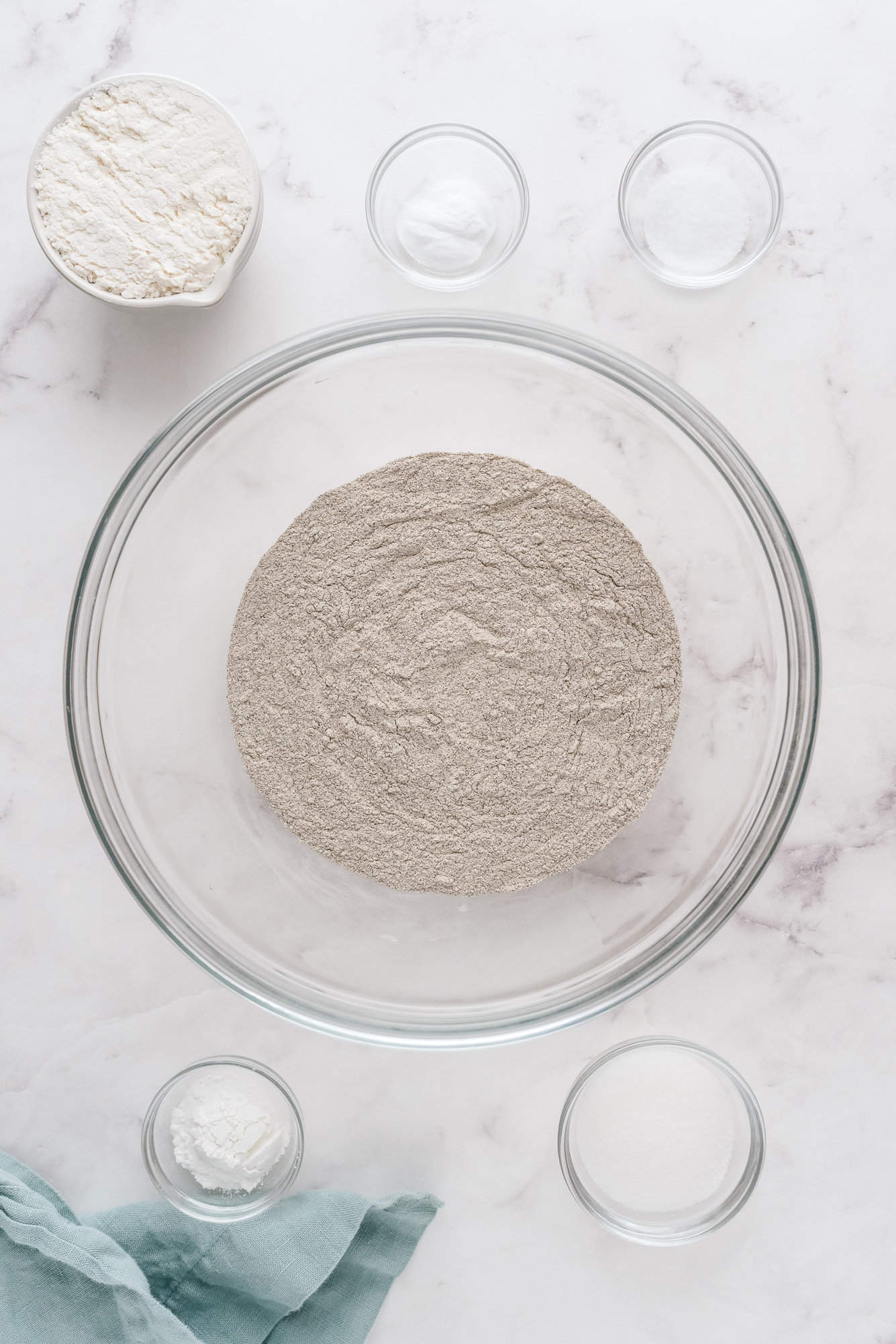 Dry ingredients, all in separate clear glass bowls.