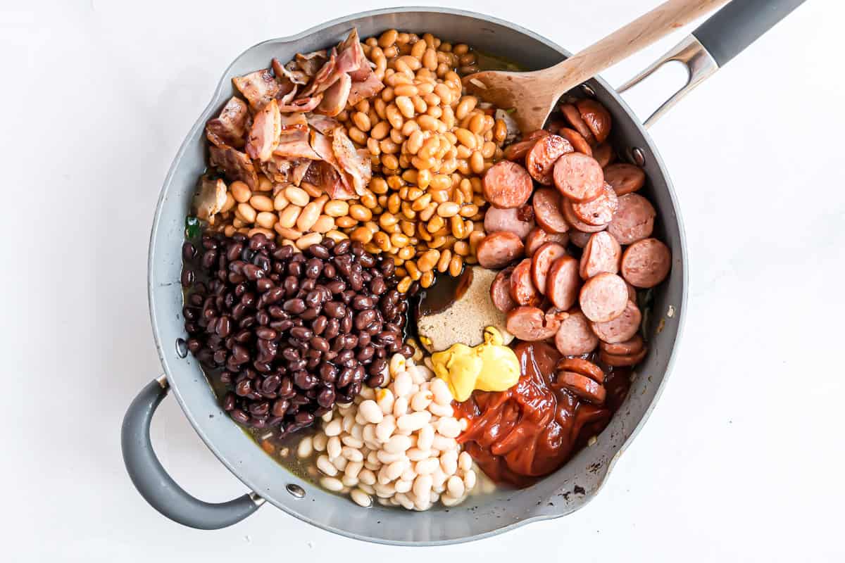 Meat and beans added to frying pan.