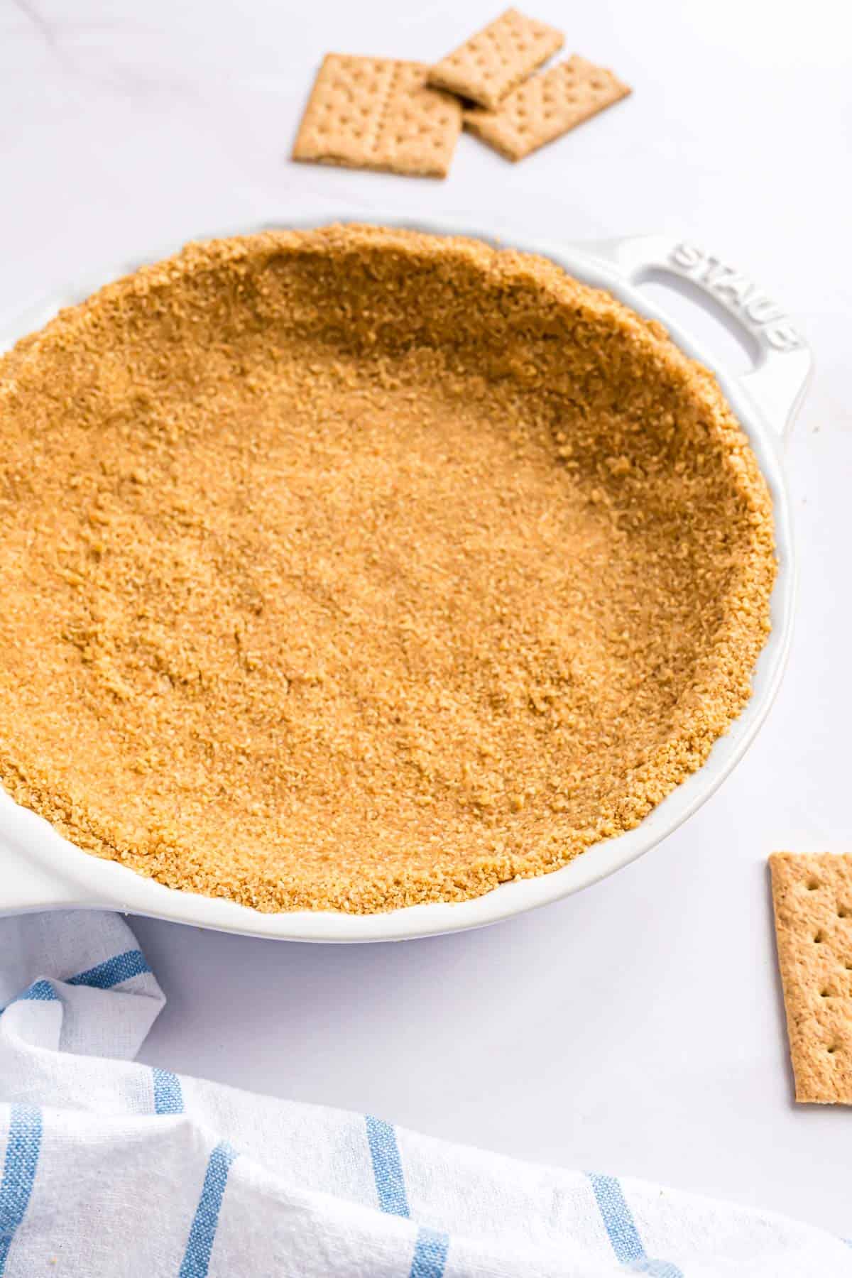 Homemade graham cracker crust in a white pie plate.