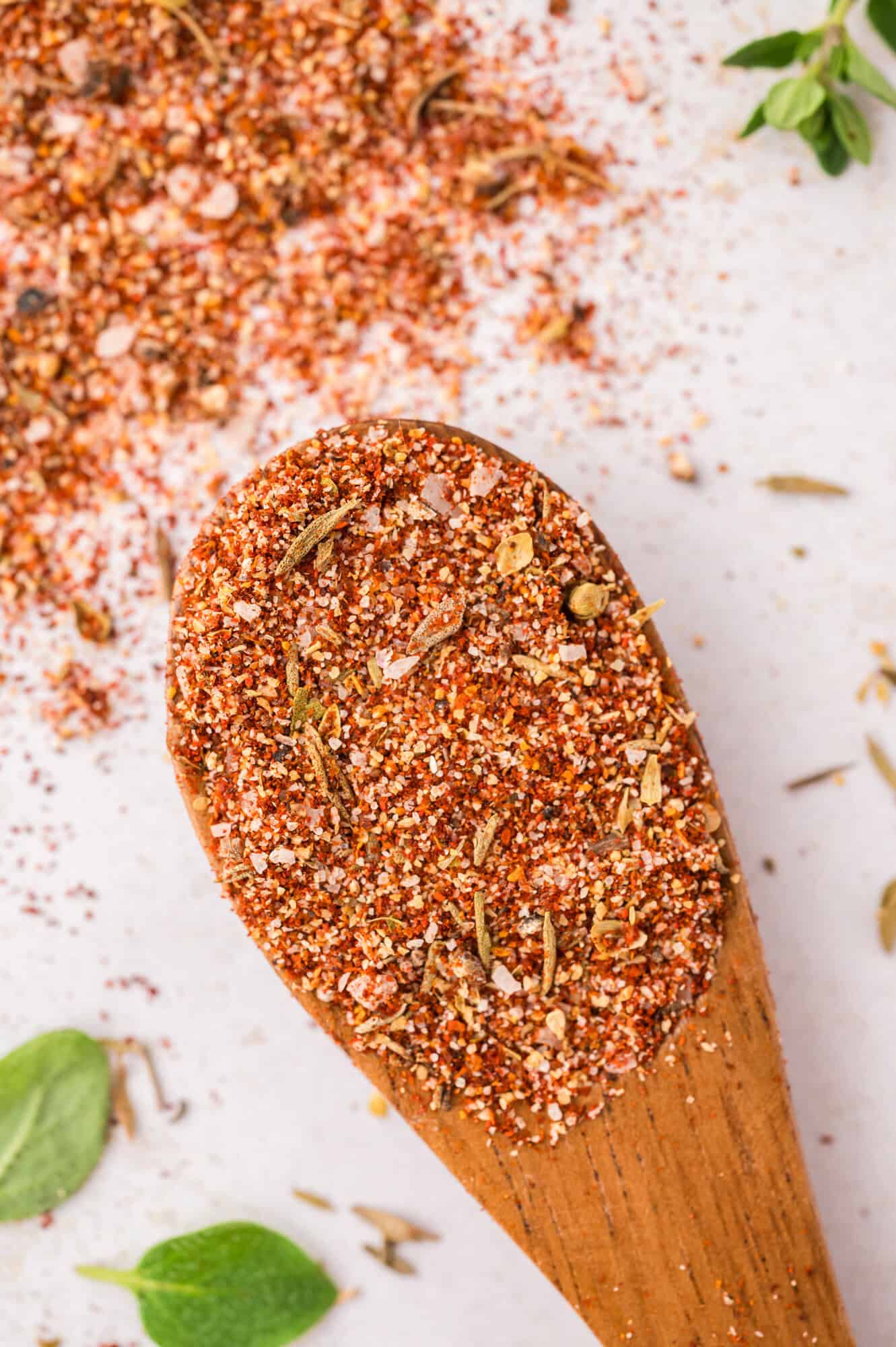 Close up of spices on a small wooden spoon.