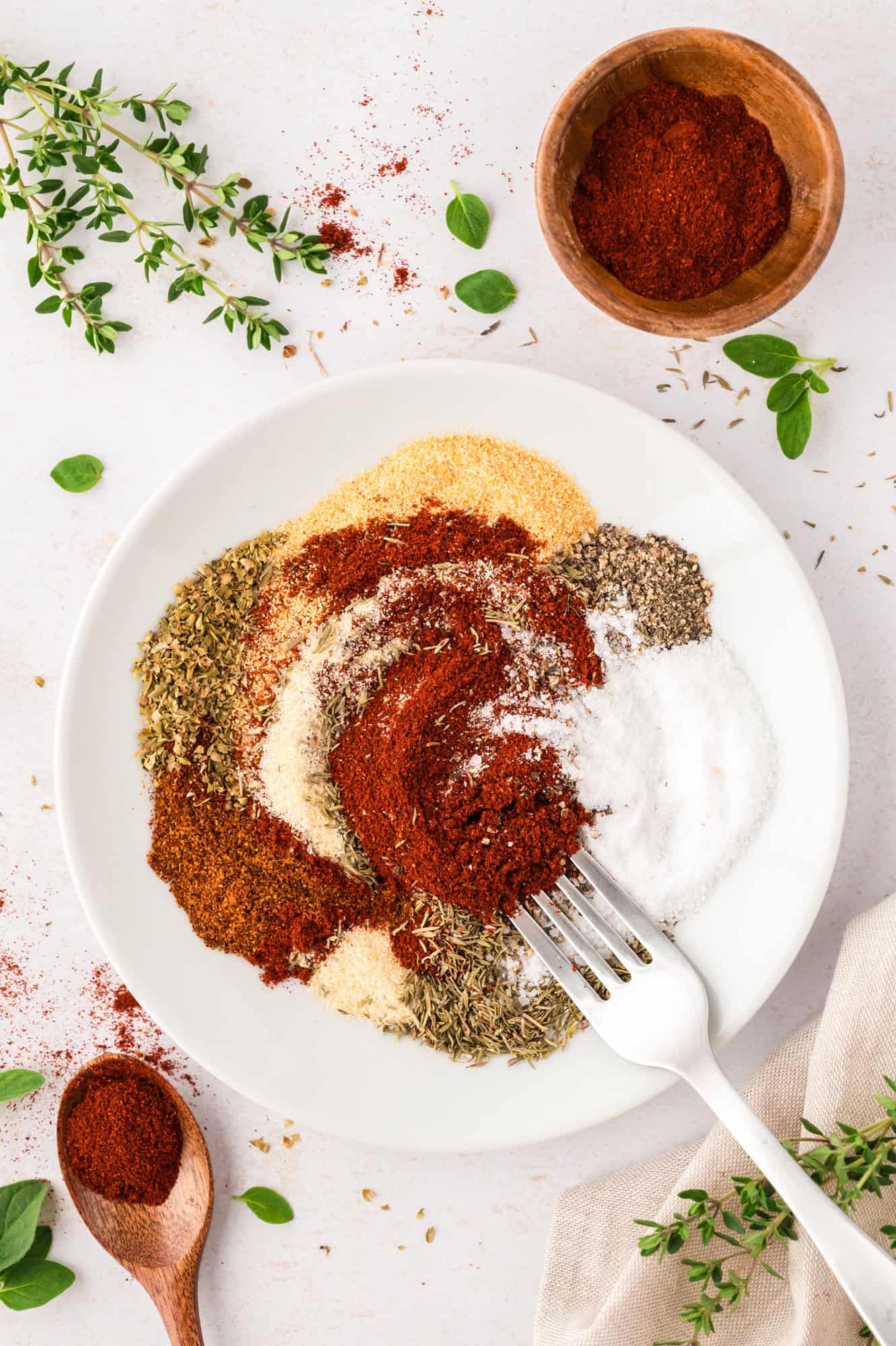 Spices partially mixed together, with a fork.