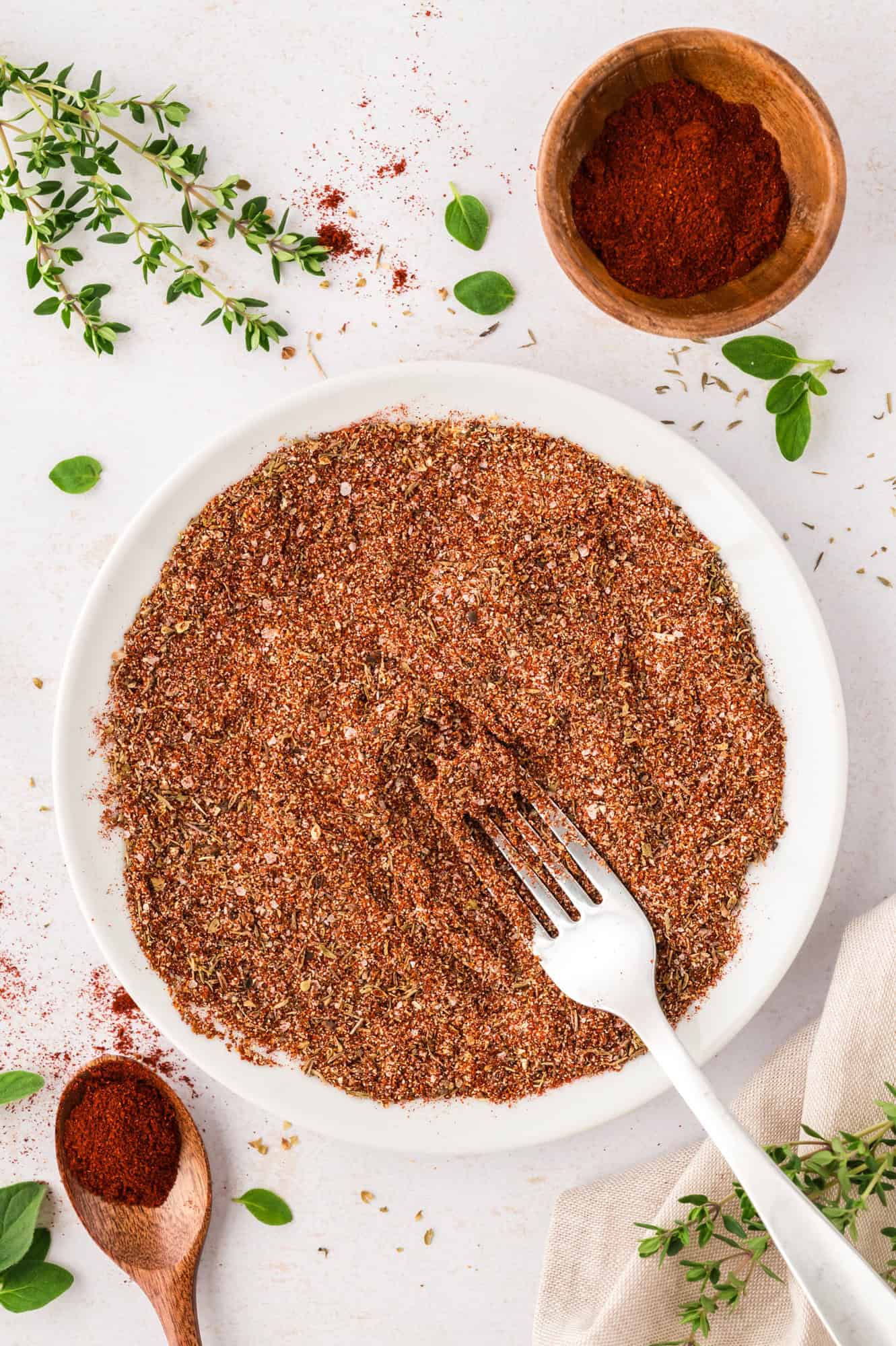 Spices fully mixed together, a fork in the bowl.