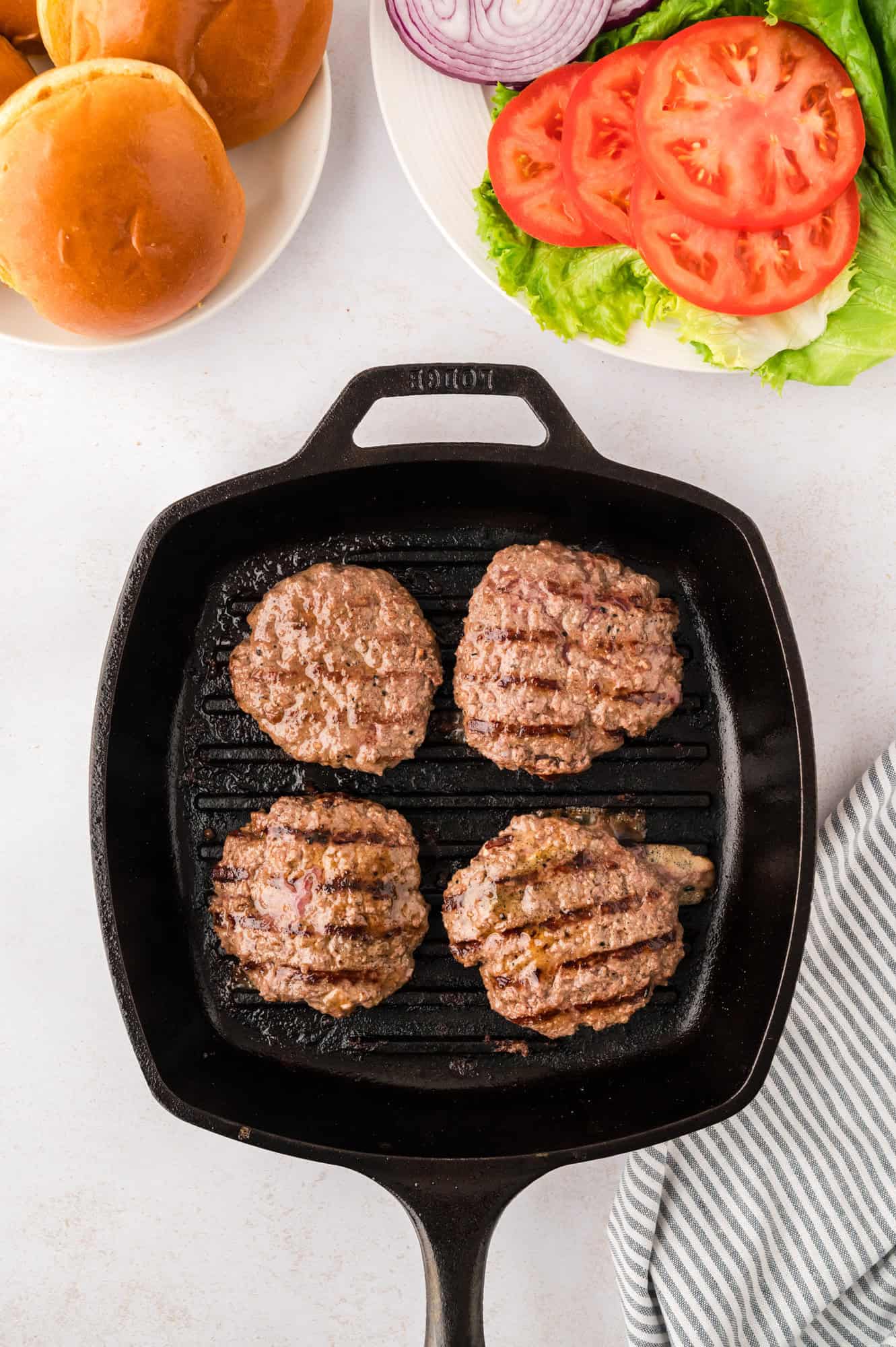 Cooked burgers on a grill pan.