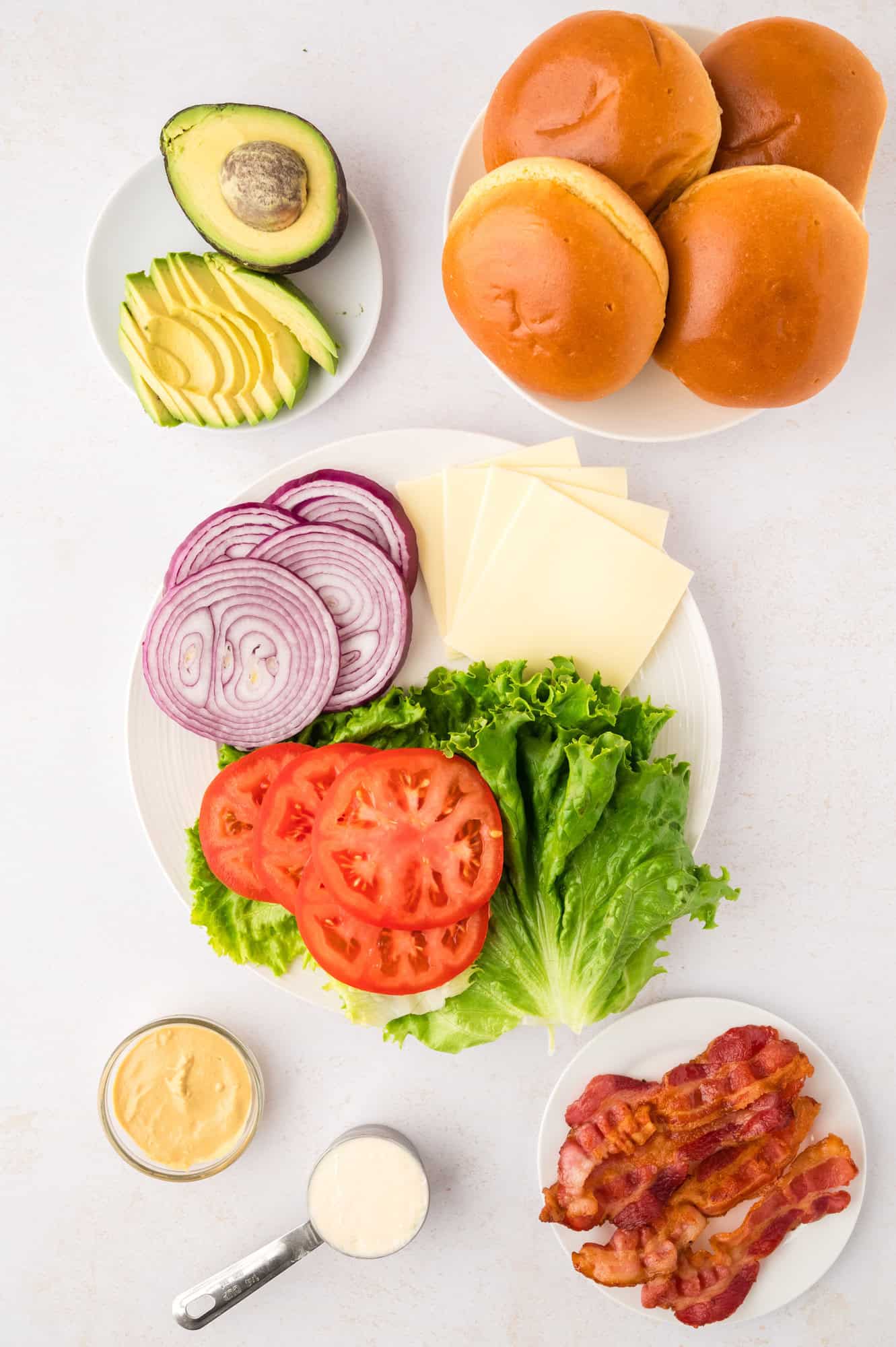 Toppings, bun, and sauce ingredients, viewed from above.
