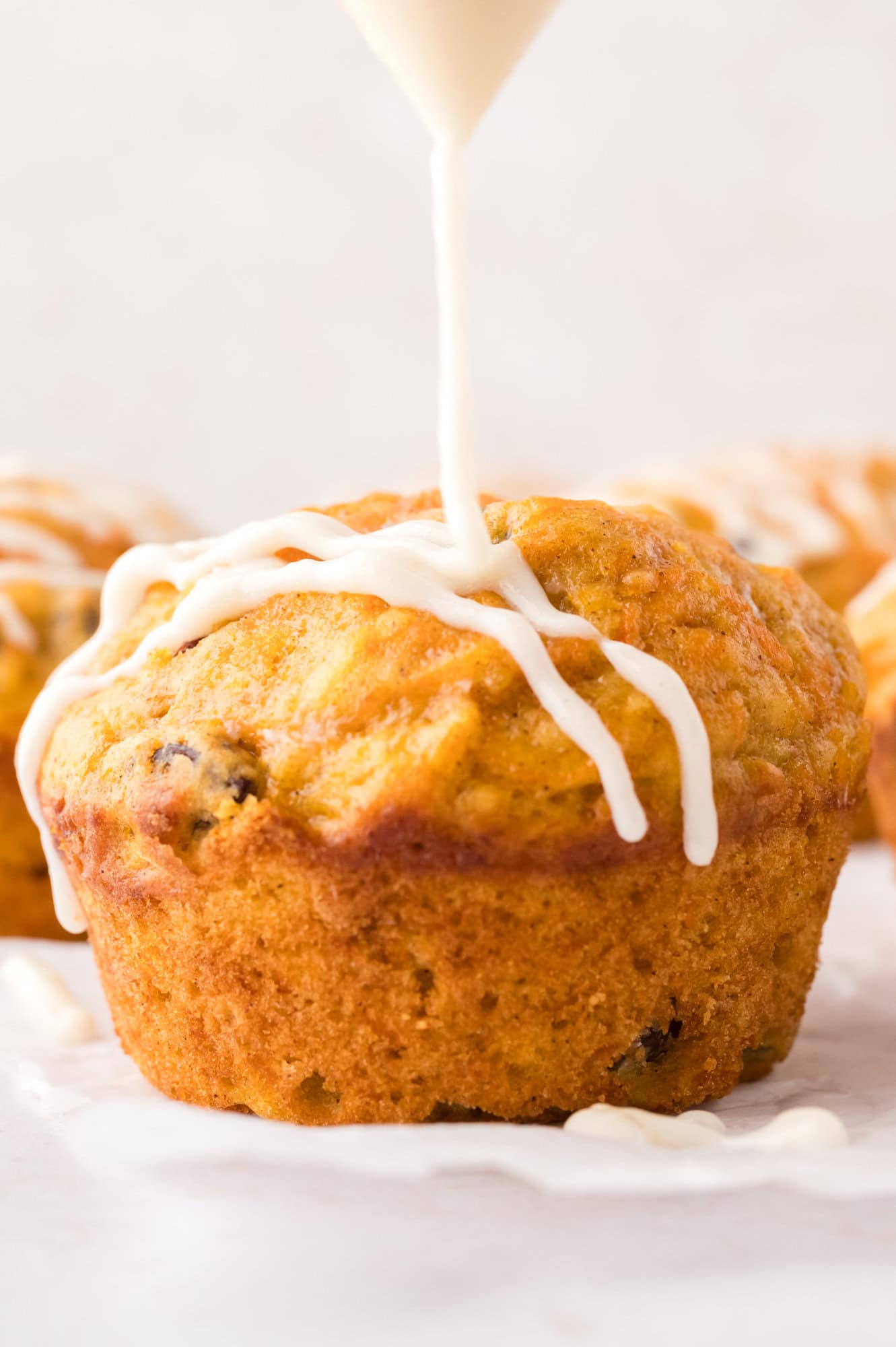 Glaze being added to muffins.