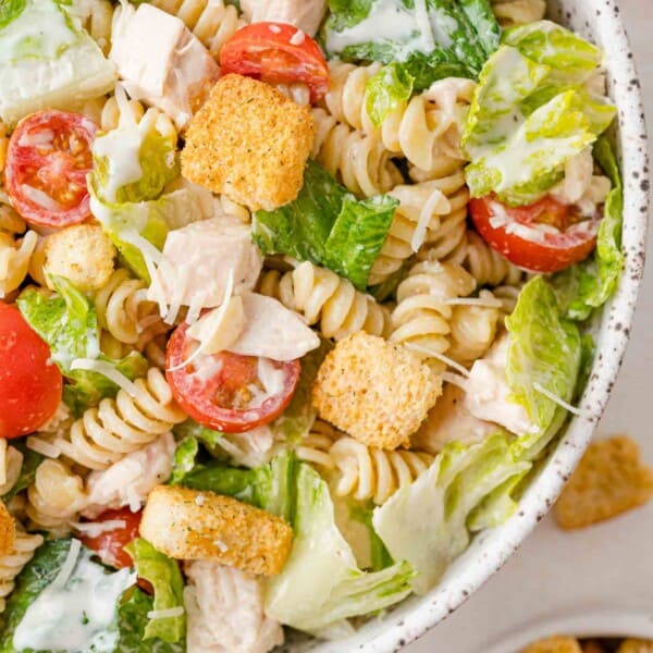 Chicken caesar pasta salad in a large serving bowl.