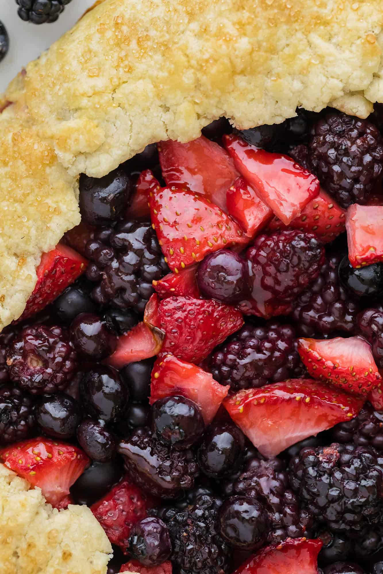 Close up of berry galette with strawberries, blueberries, balckberries.