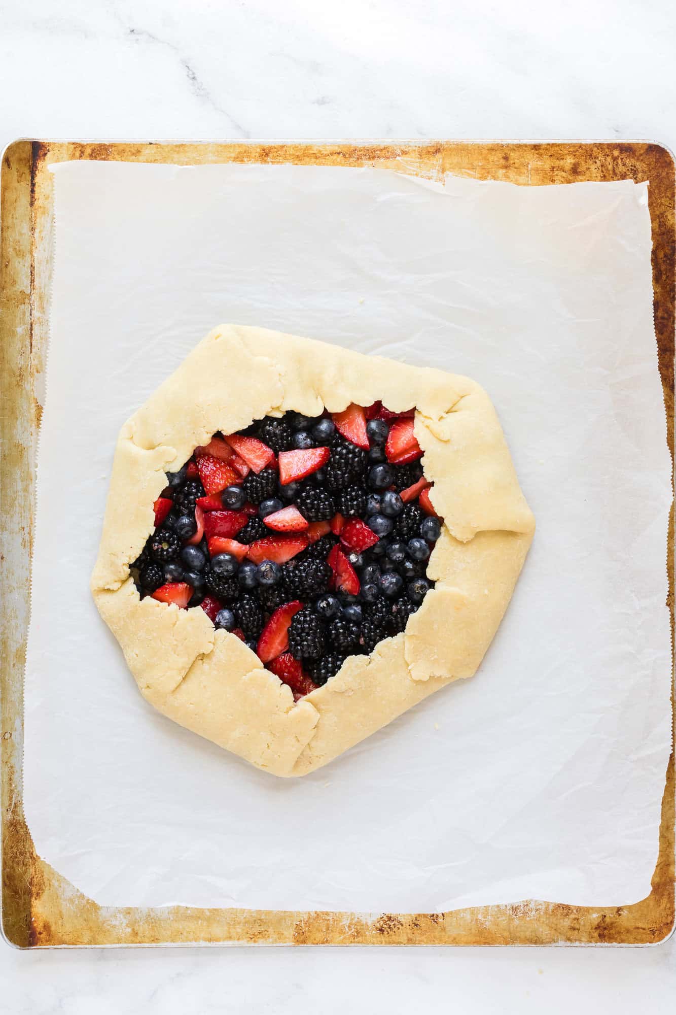 Berry galette on a sheet pan, before baking.