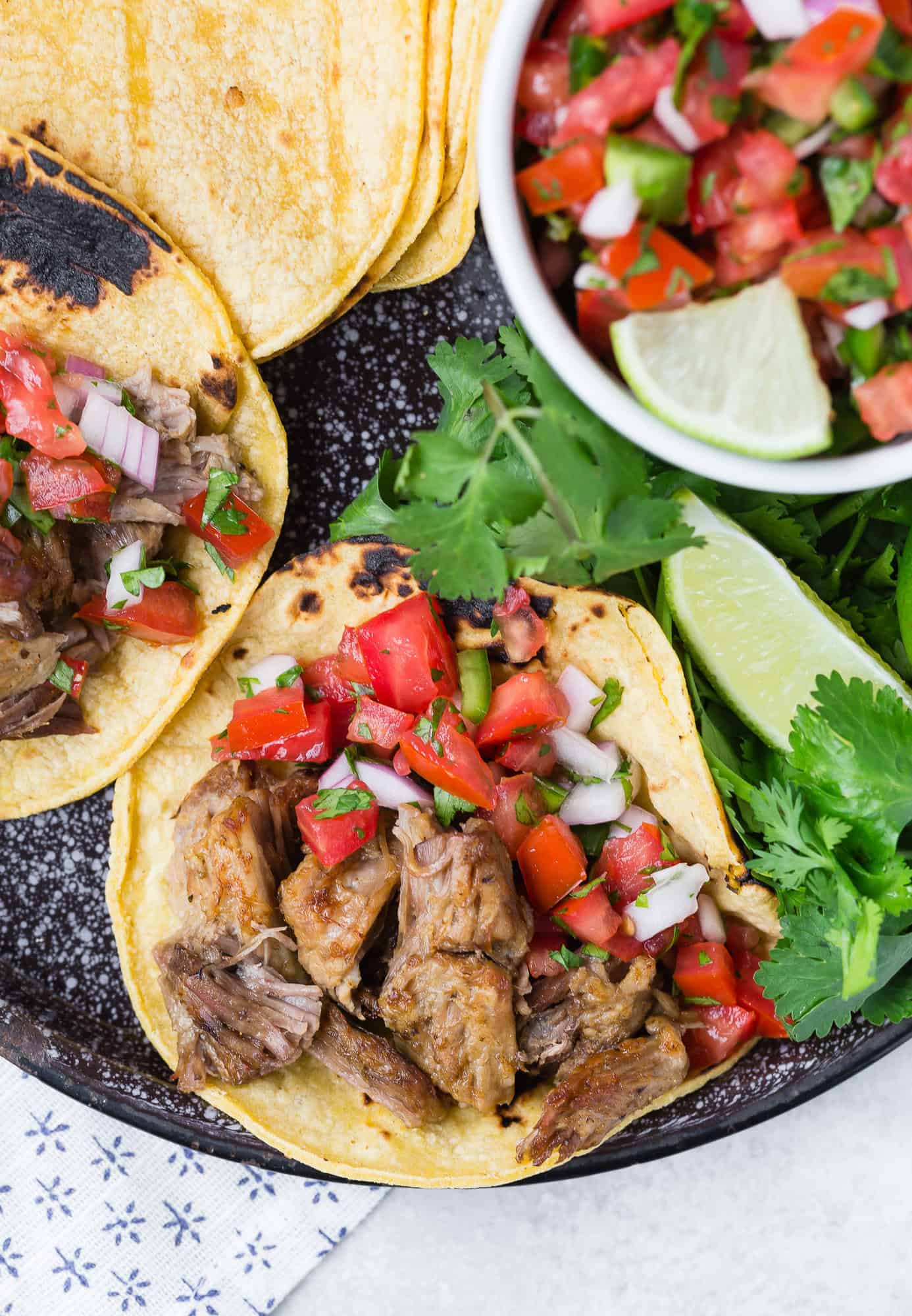 Carnitas on a corn tortilla with pico de gallo.