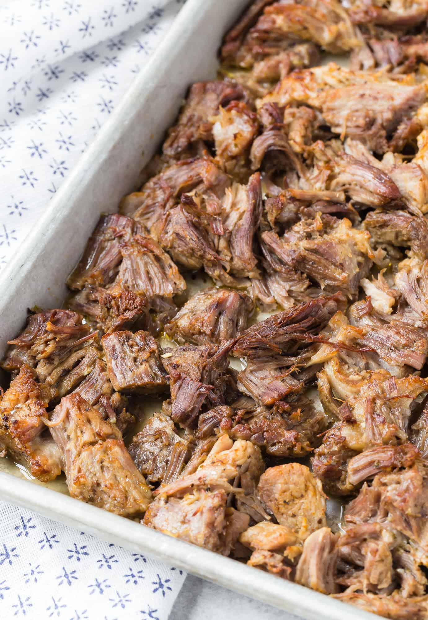 Carnitas, after crisping, on a sheet pan.