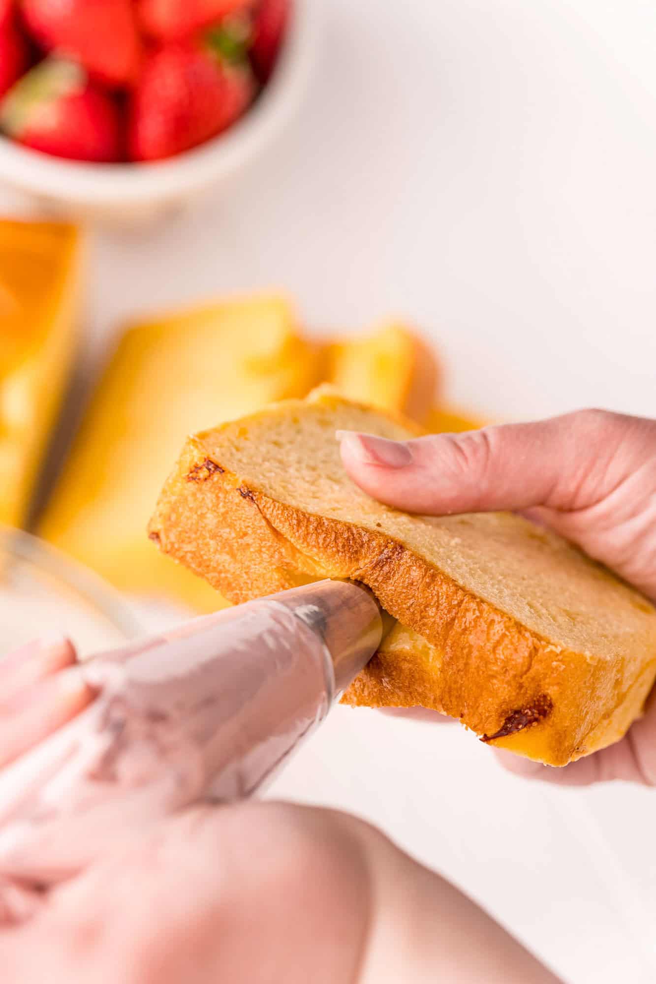 Piping bag inserted into bread.