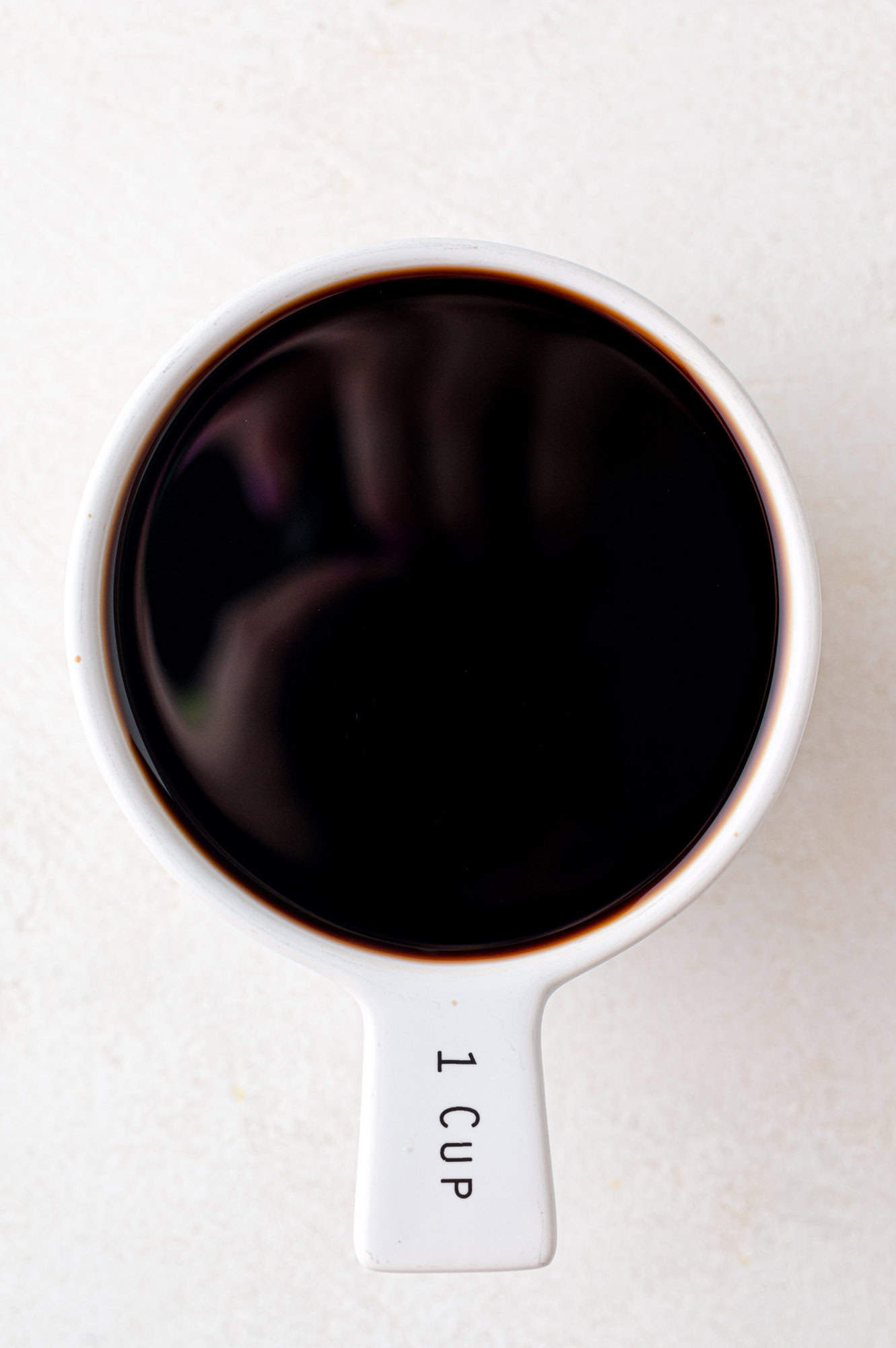 Balsamic vinegar measured into a 1 cup measuring cup.