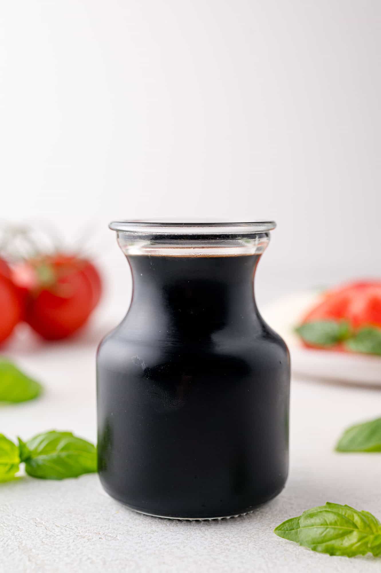 Balsamic reduction in a small glass carafe.