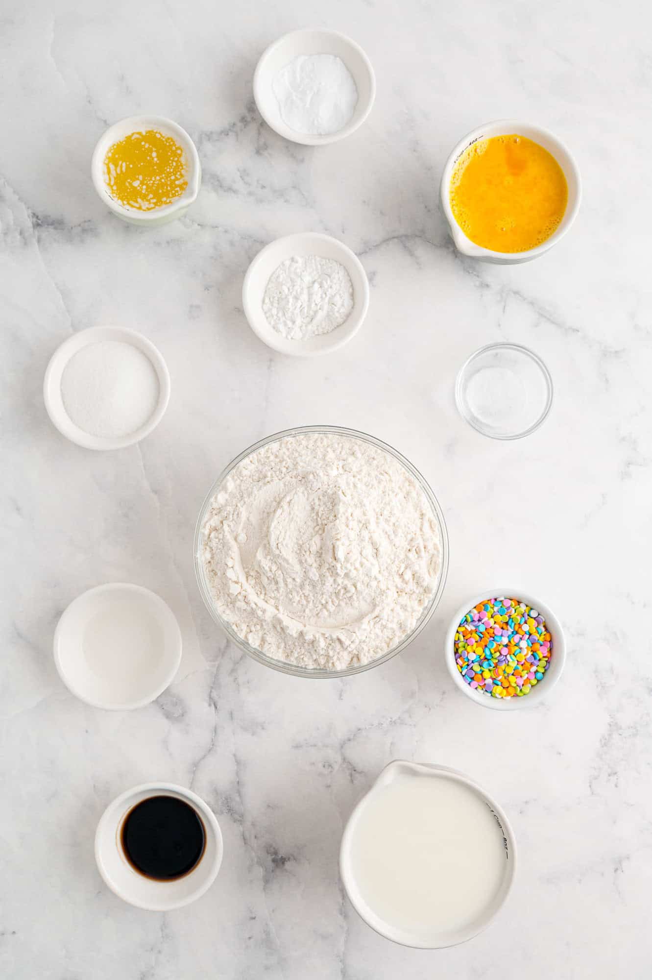 Overhead view of ingredients needed for birthday cake pancakes.