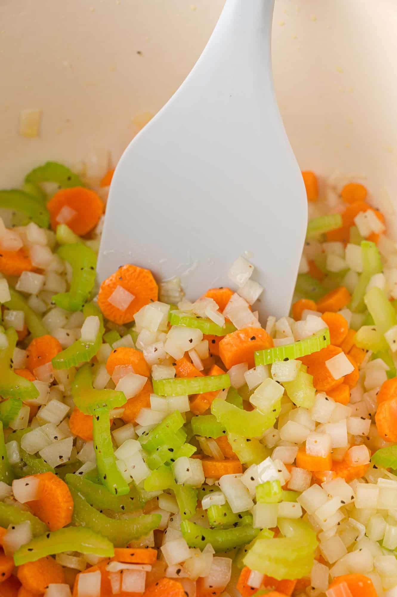 Onions, celery, and carrots being sauteed.