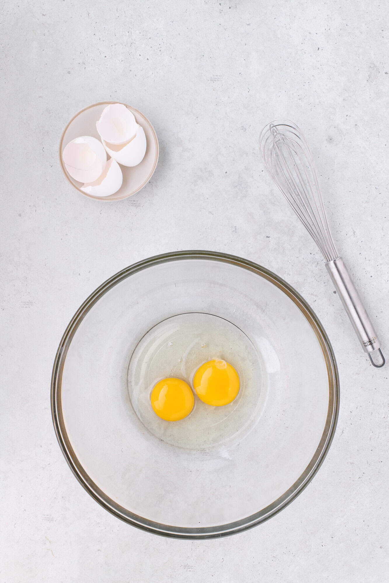 Eggs cracked in a large mixing bowl.