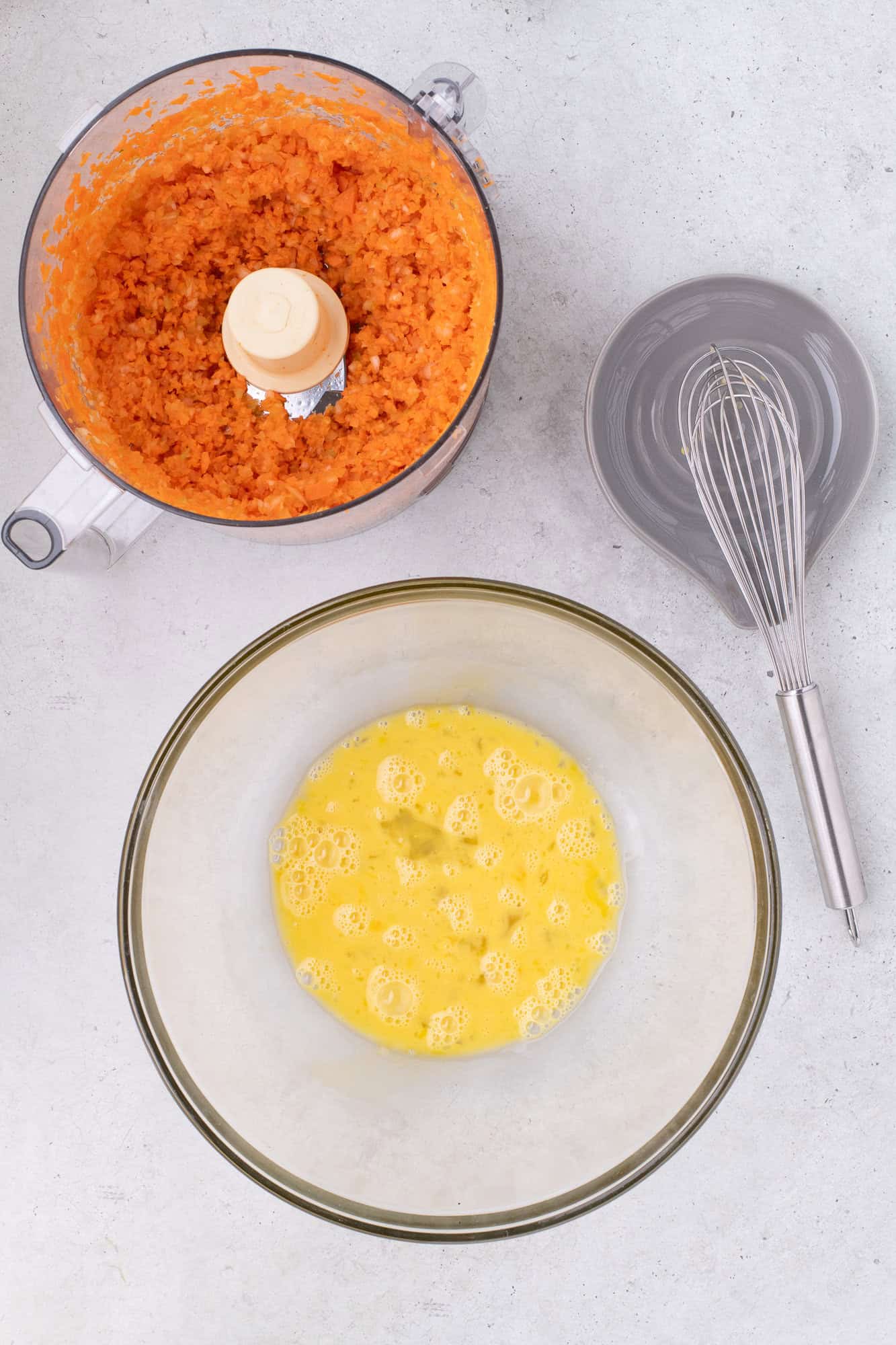 Eggs beaten in a large mixing bowl.