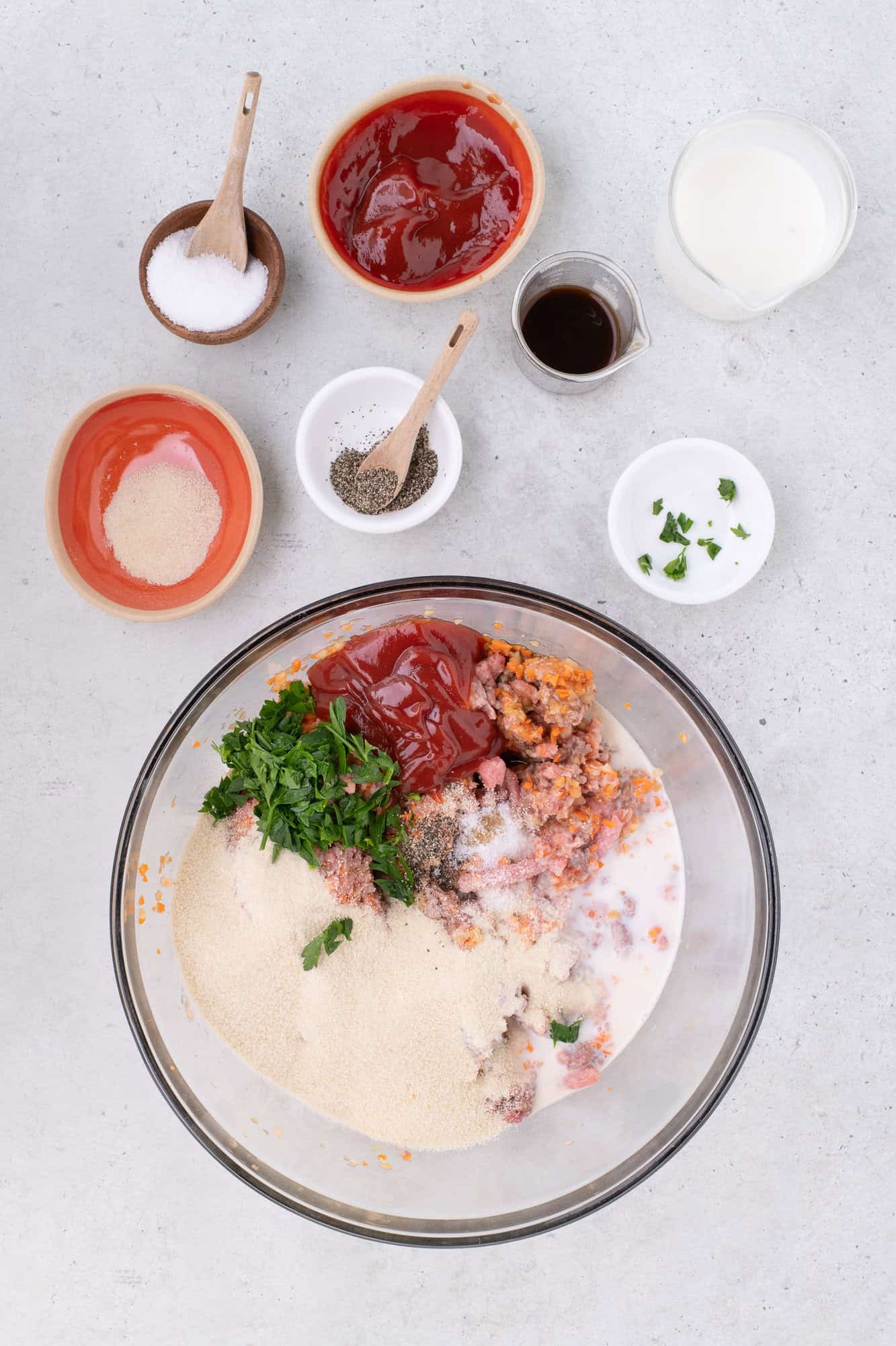 All ingredients for meatloaf in a large mixing bowl, not yet mixed.