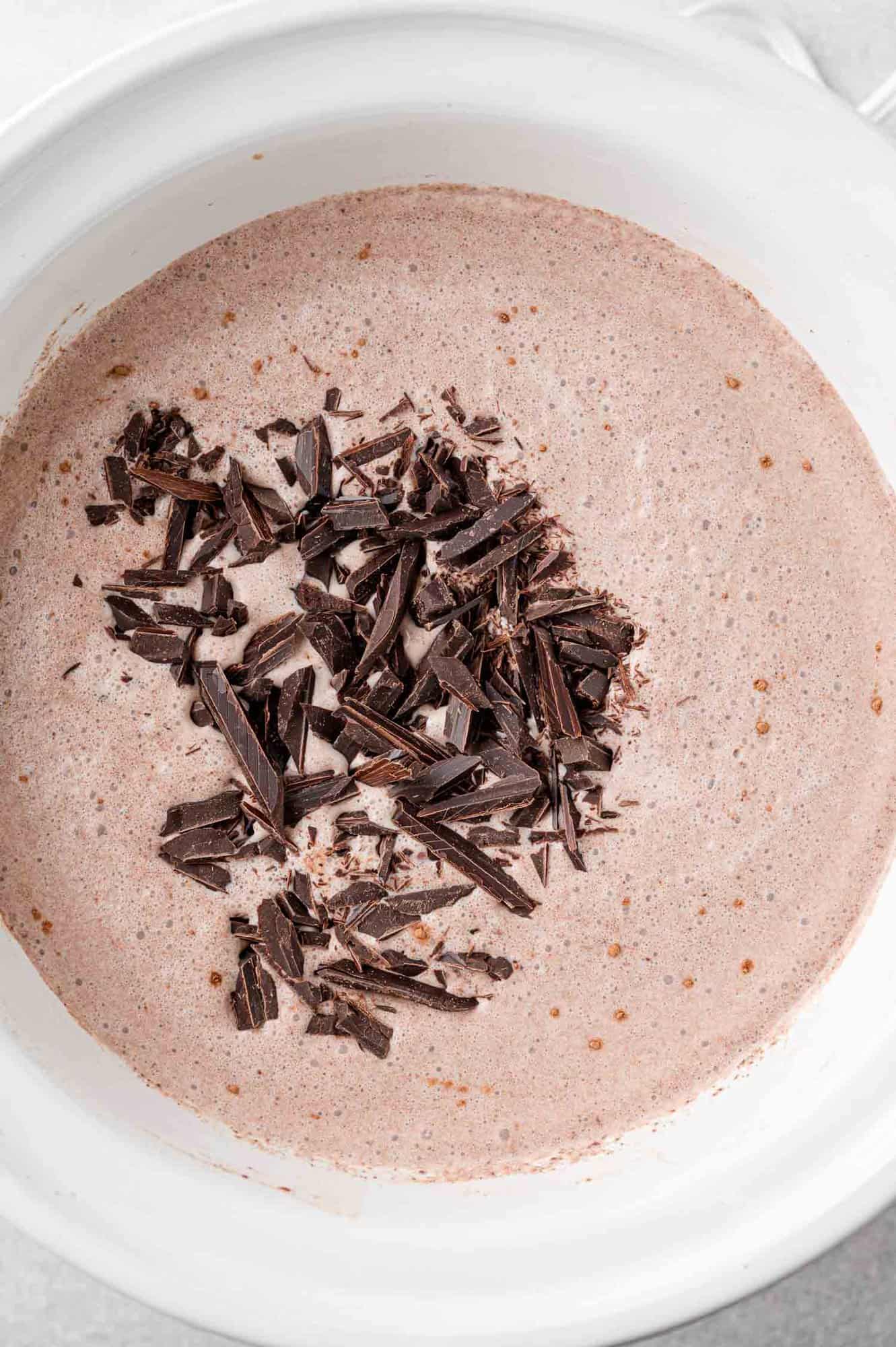 Chopped chocolate added to hot cocoa.