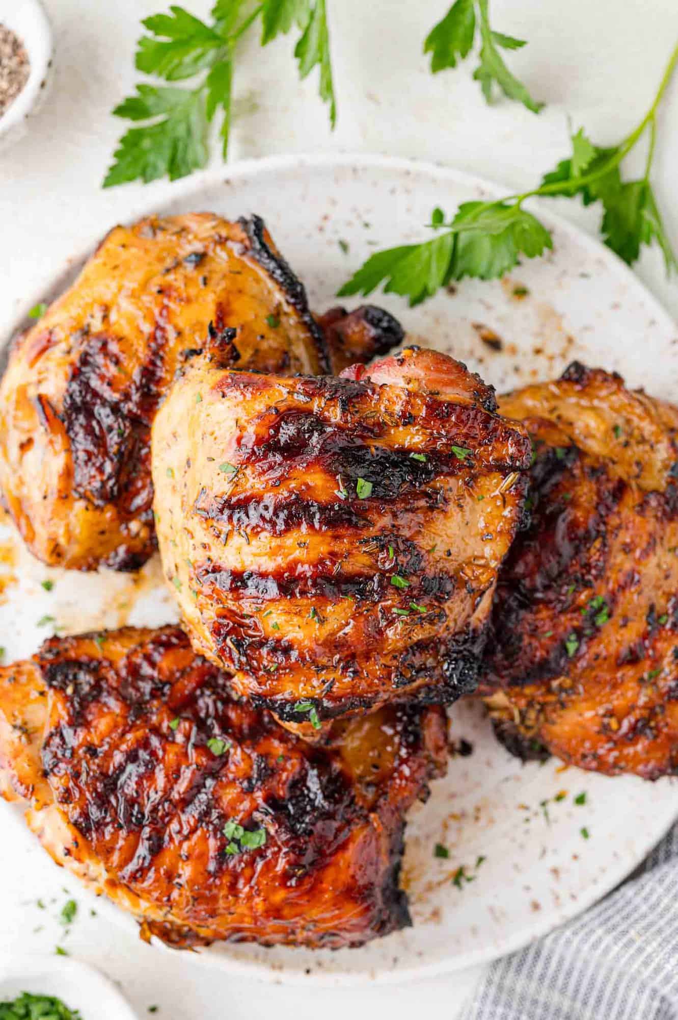 Grilled chicken thighs on a plate.