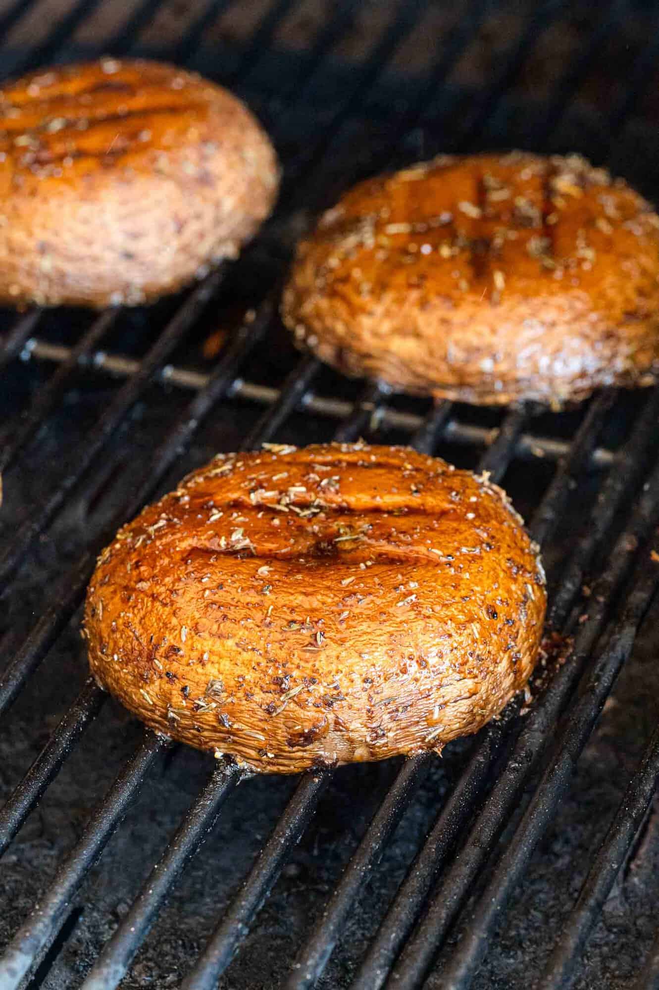 Portobello mushrooms being grilled.