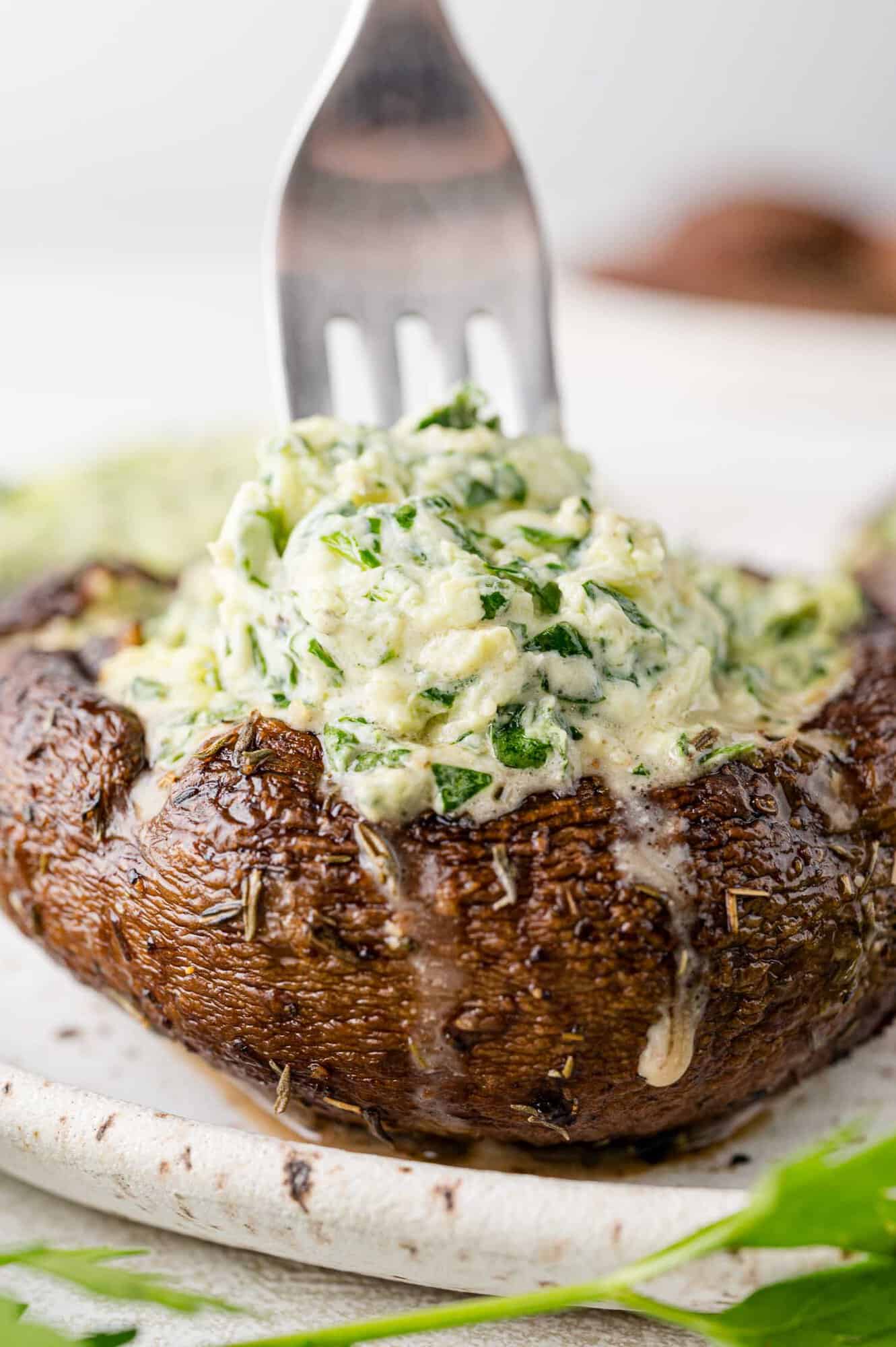 Fork going into a stuffed portobello mushroom.
