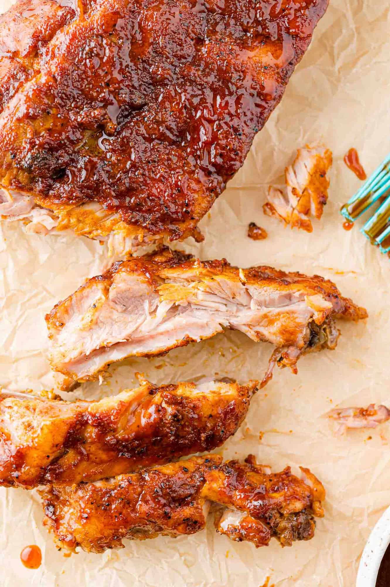 Rack of barbecue ribs, partially cut.