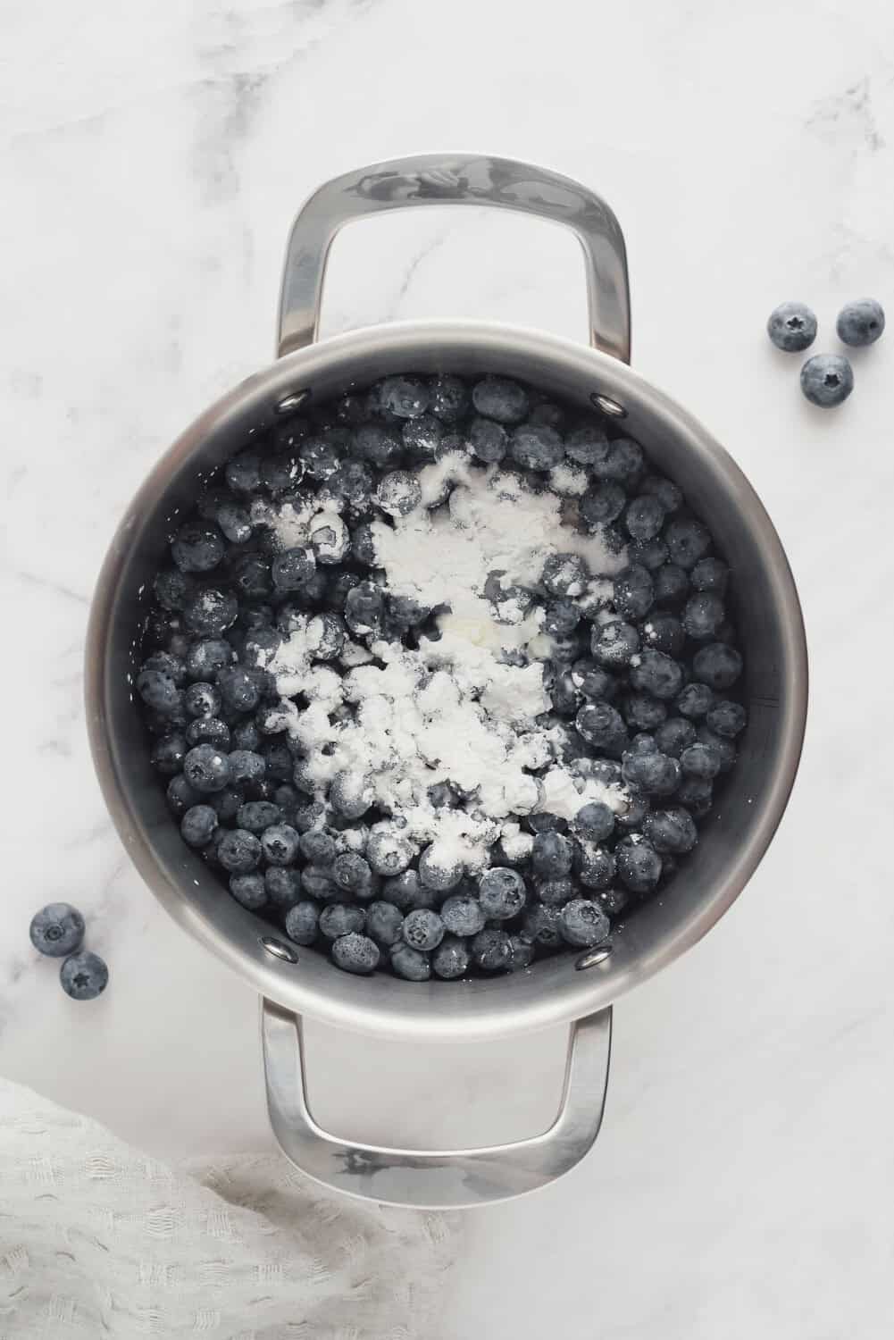 Blueberry sauce in pan before stirring or cooking.