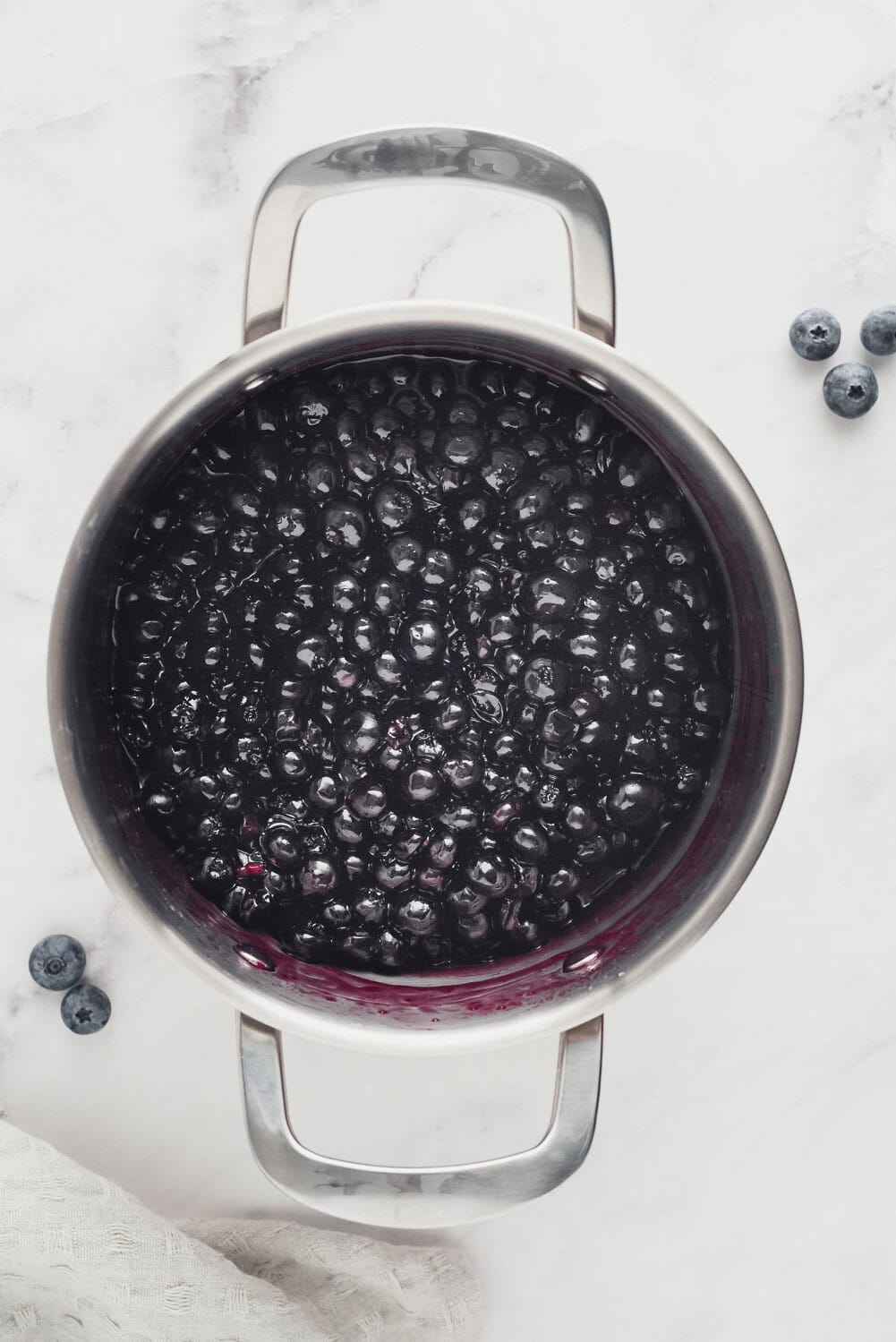 Blueberry sauce in pan after cooking.