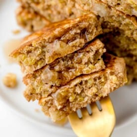 Apple quinoa pancakes on a fork with syrup.