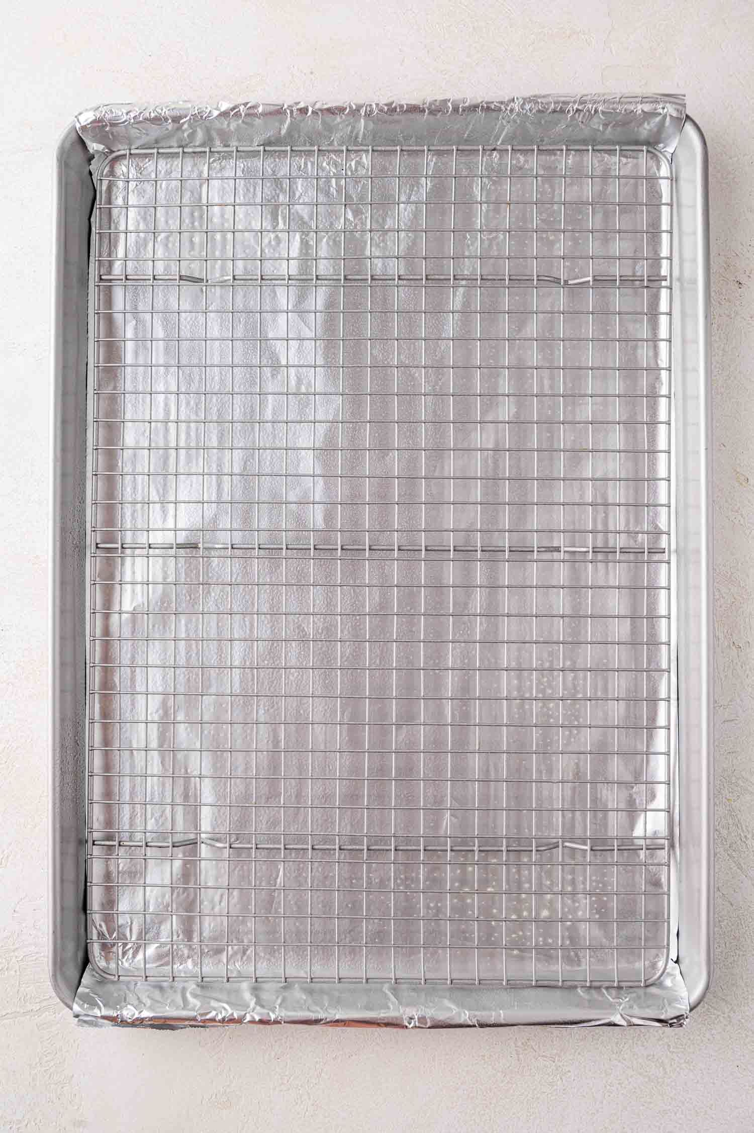 Sheet pan lined with foil, wire cooking rack placed on top.