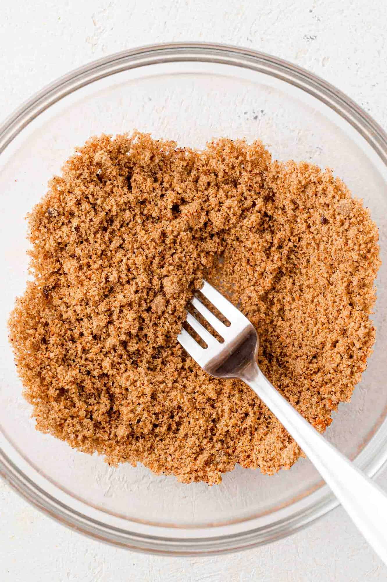 Spice rub for bacon wrapped dates, being stirred with a fork.