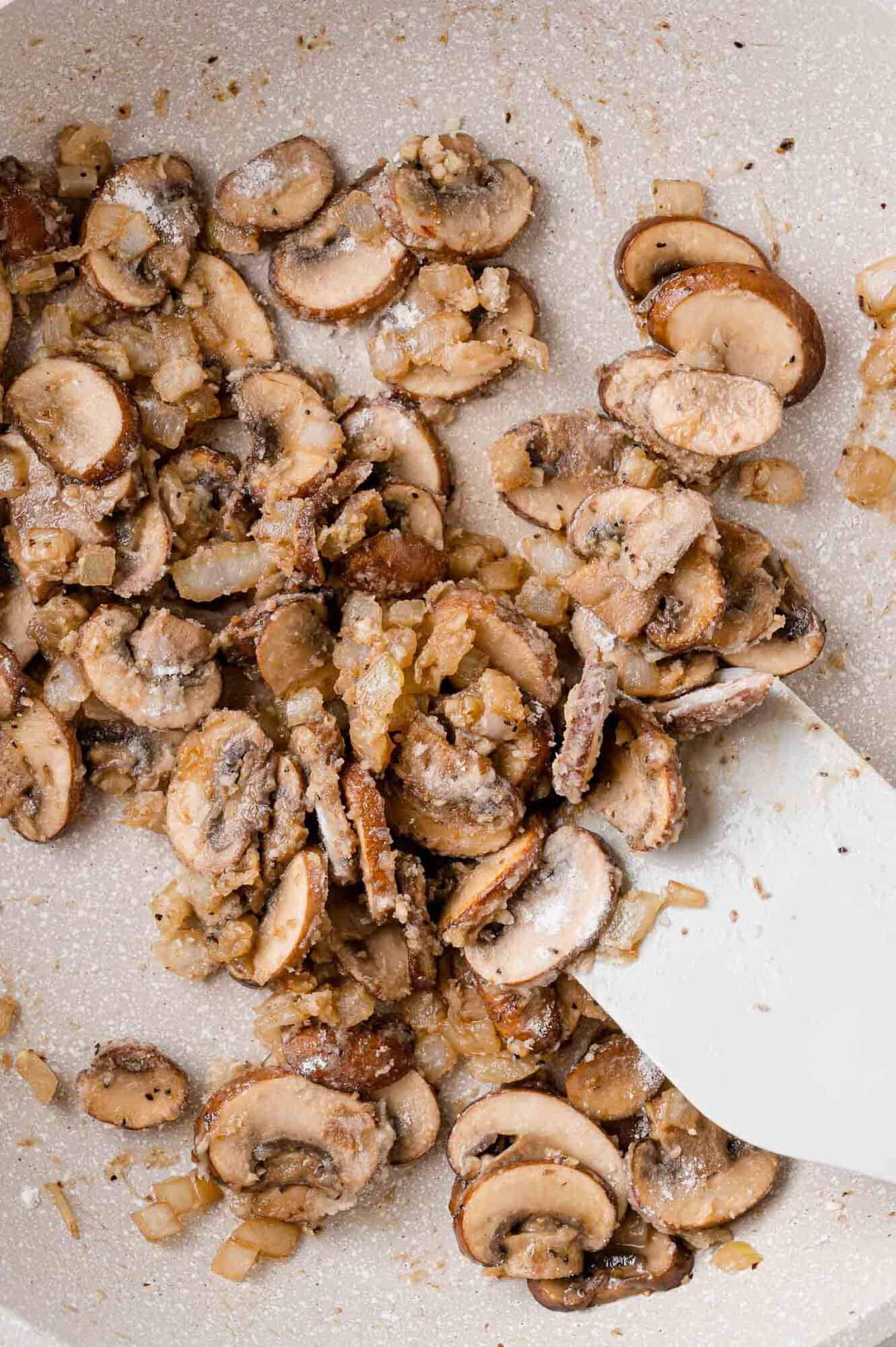Flour added to mushrooms and onions.