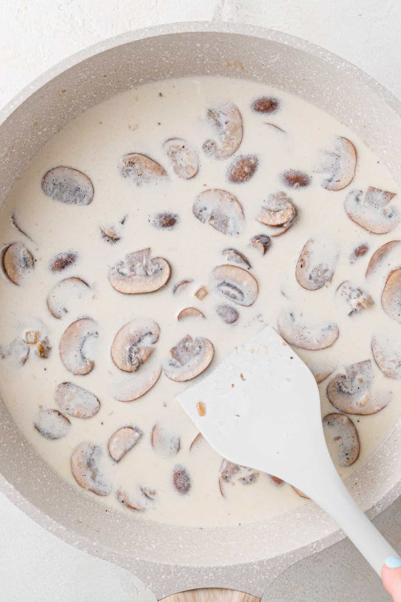 Half and half and chicken broth added to pan.